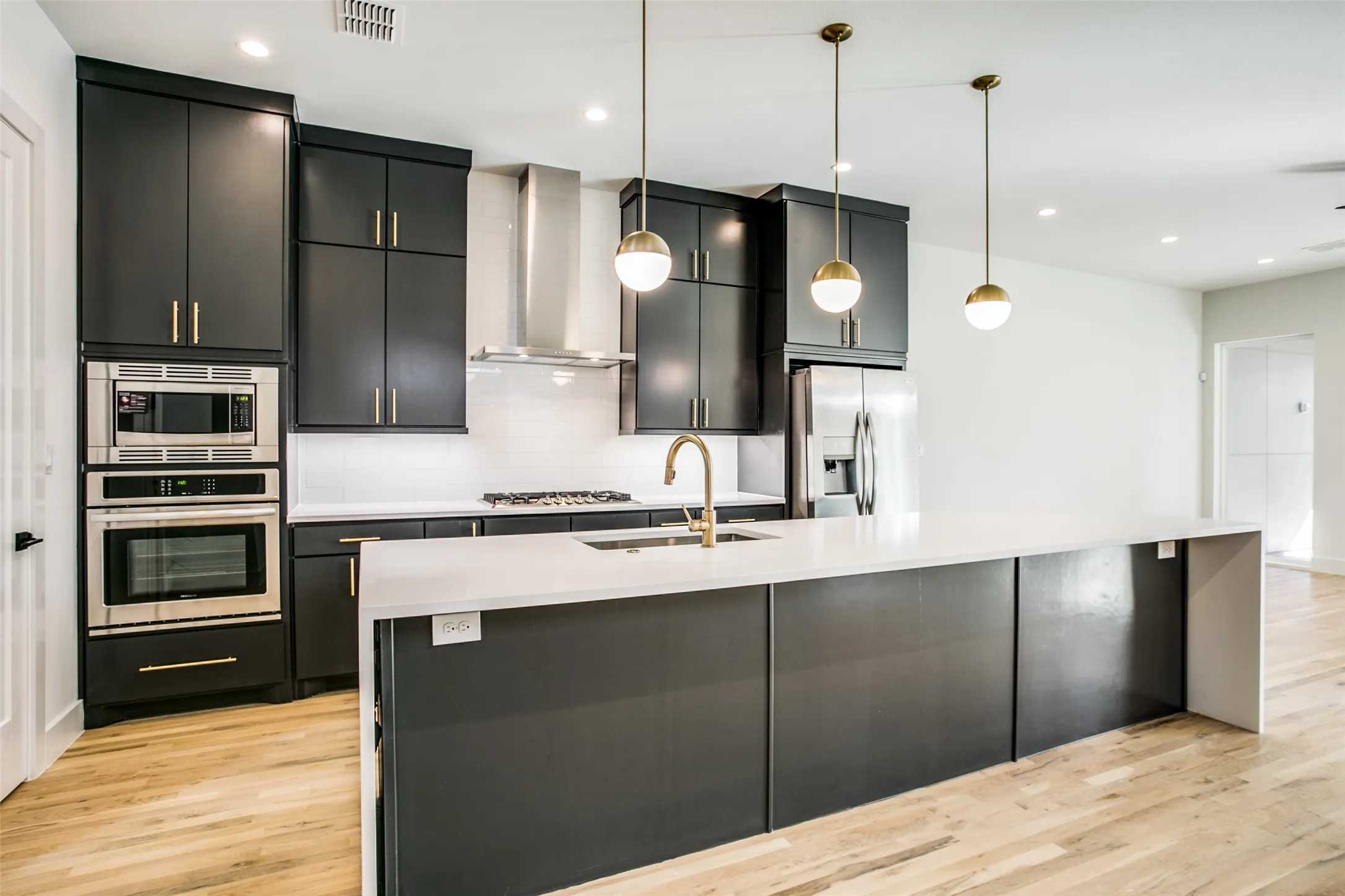 Quartz counters through out property. White subway tile, designer lighting, gold hardware, gas cook top, built in over, microwave. Refrigerator included.