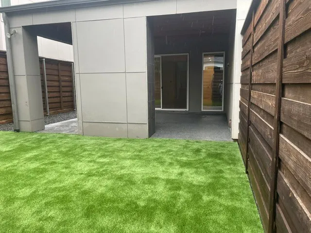 Showing the yard updated with artificial turf and epoxy finish patio