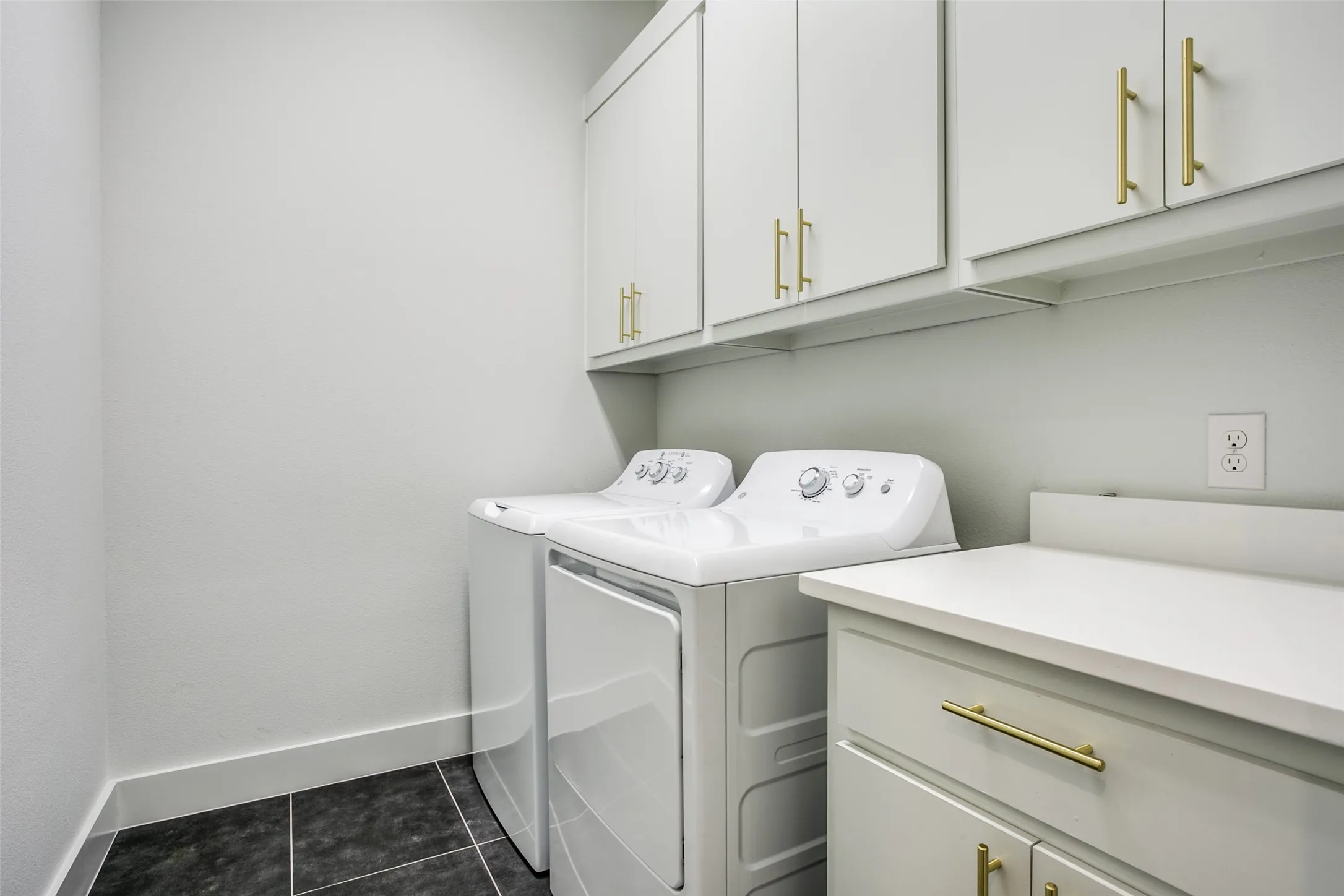 Wonderful storage in this laundry room complete with washer and dryer.