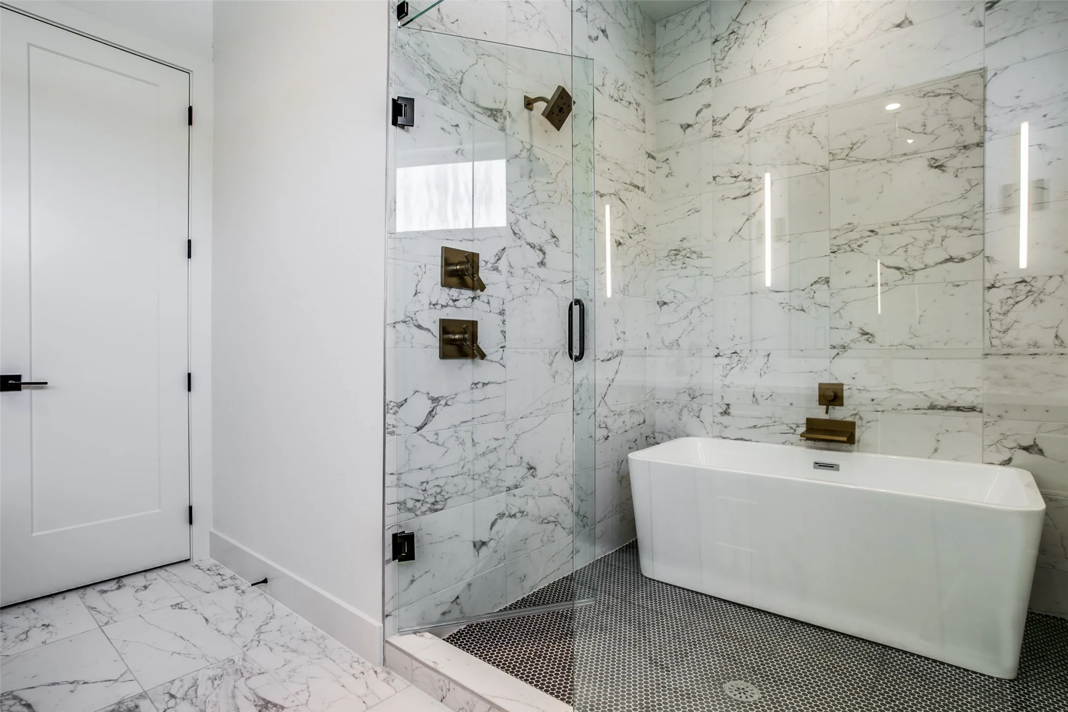 Frameless glass enclosed spa bath featuring shower and soaking tub.