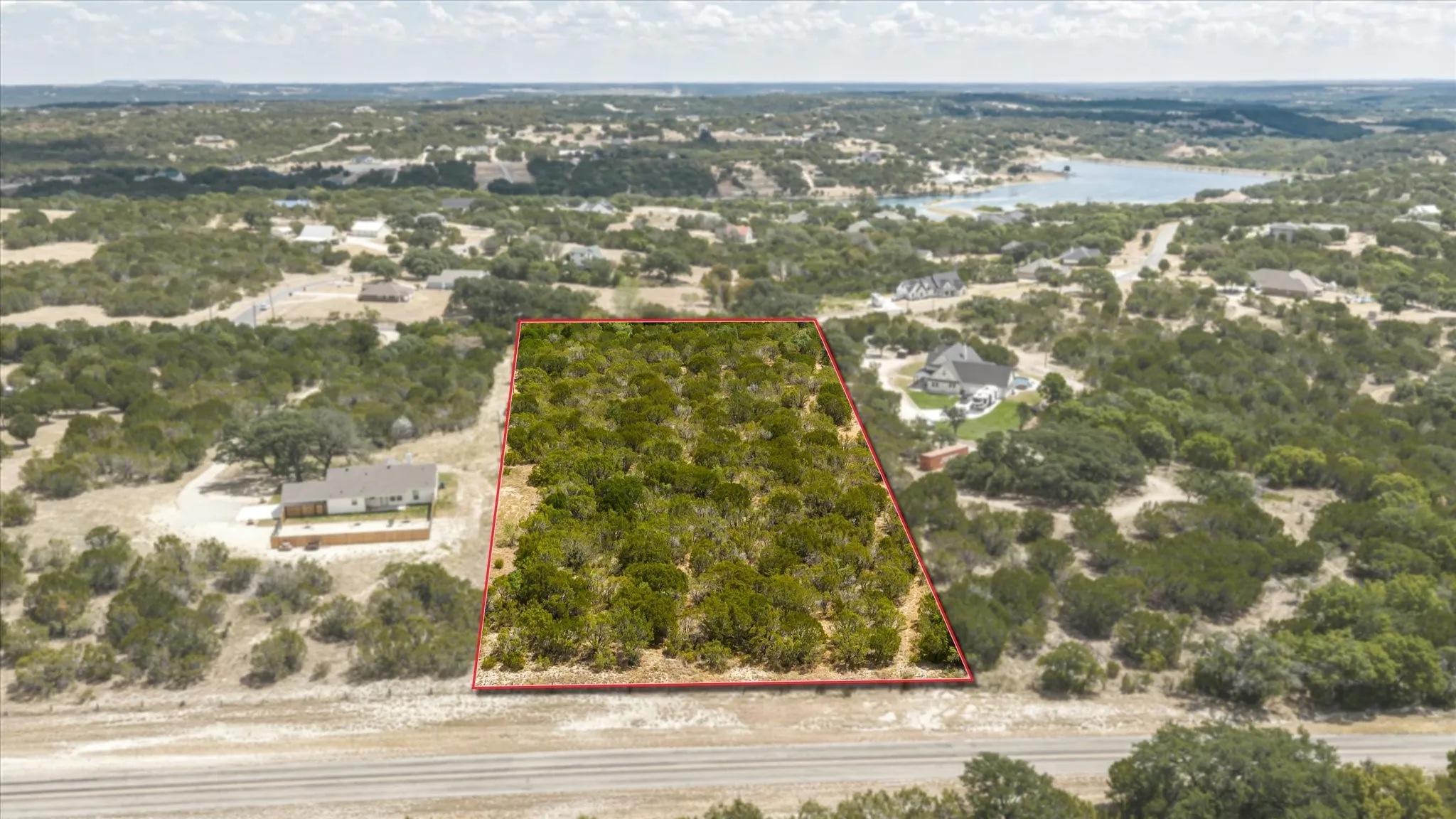 Expansive undeveloped lot with abundant mature trees and surrounding natural terrain