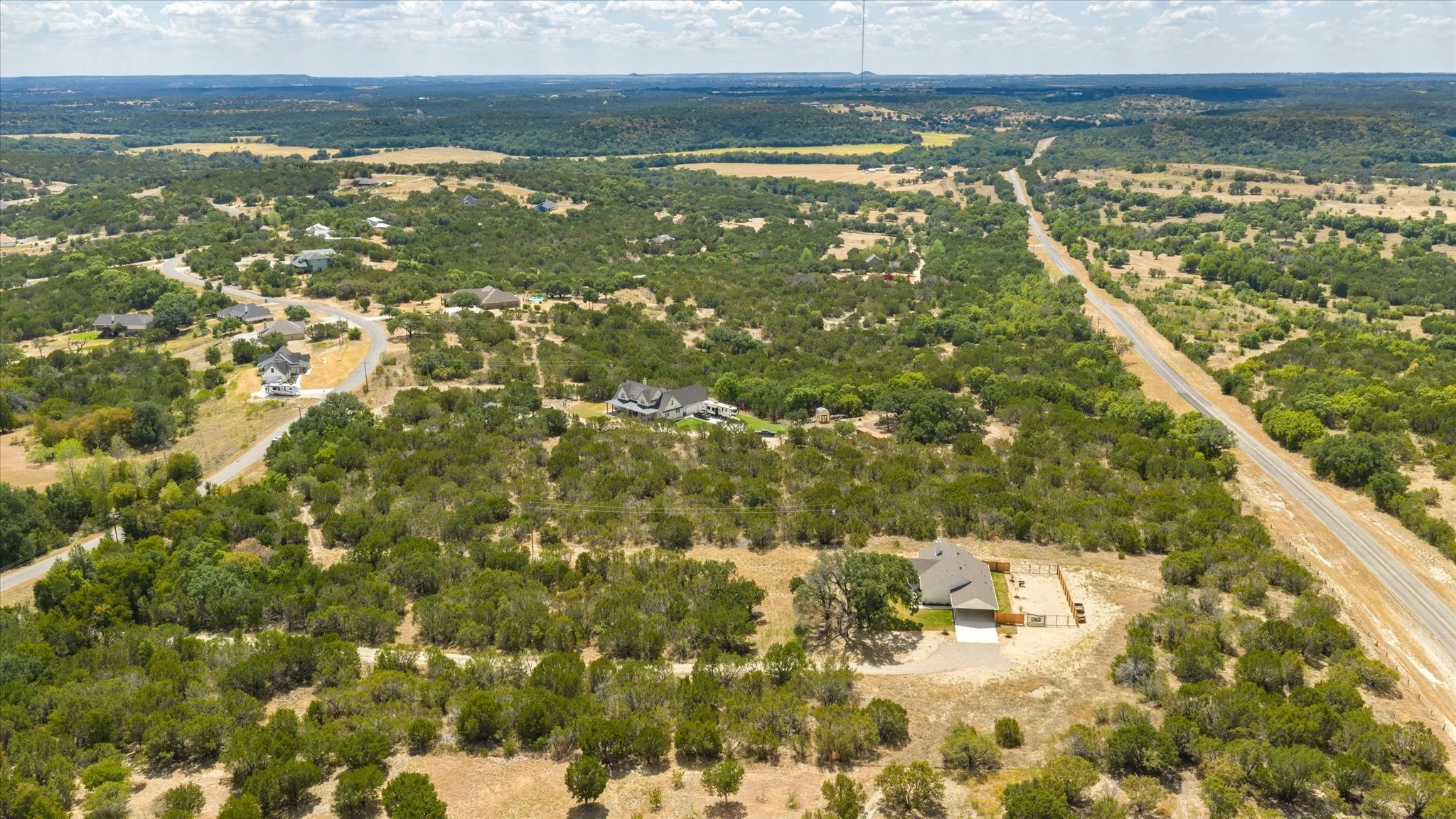 Expansive property offering a rural setting with scattered residential dwellings and extensive tree coverage
