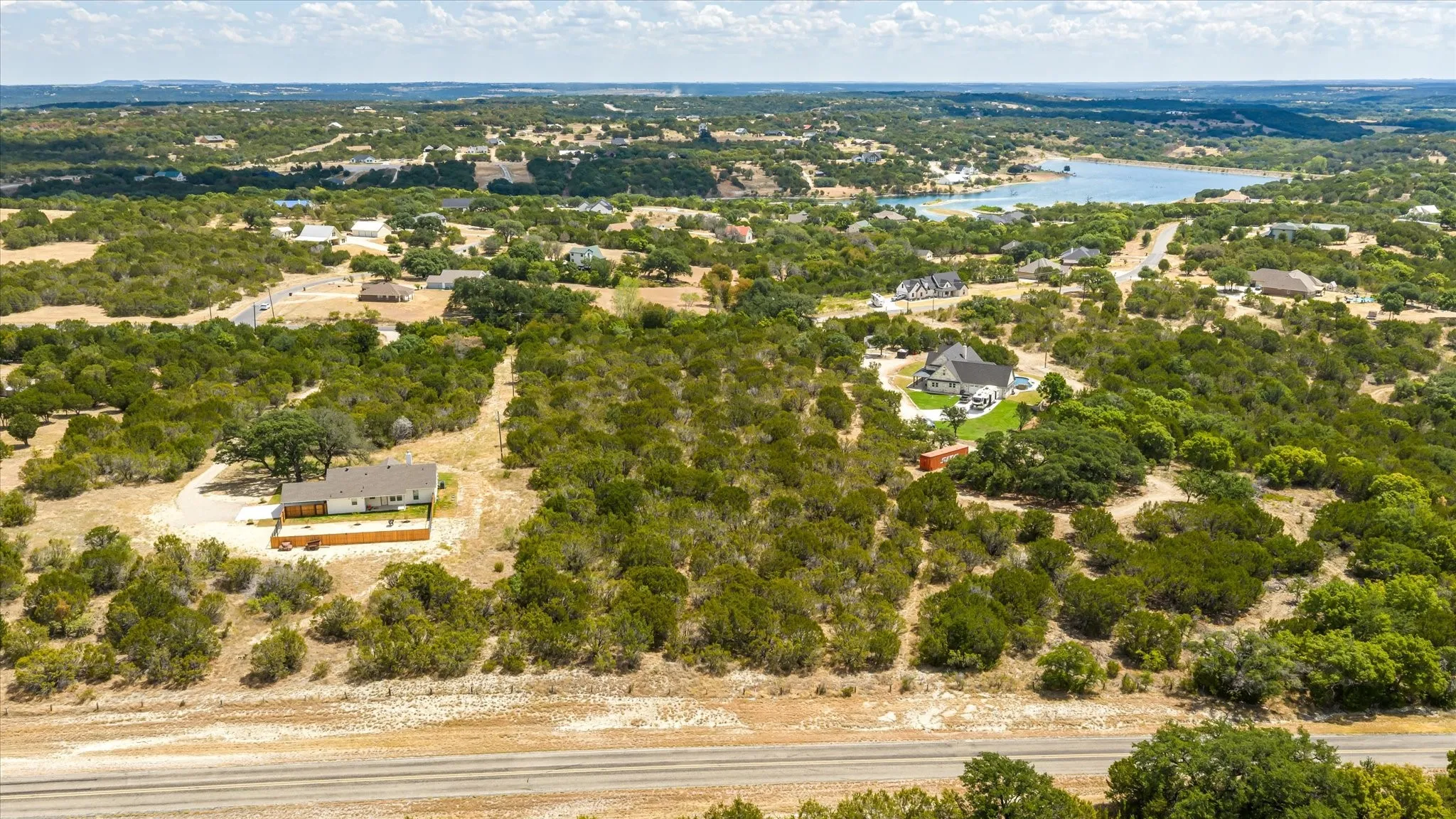 Expansive property with mature trees, offering a private setting with surrounding residences