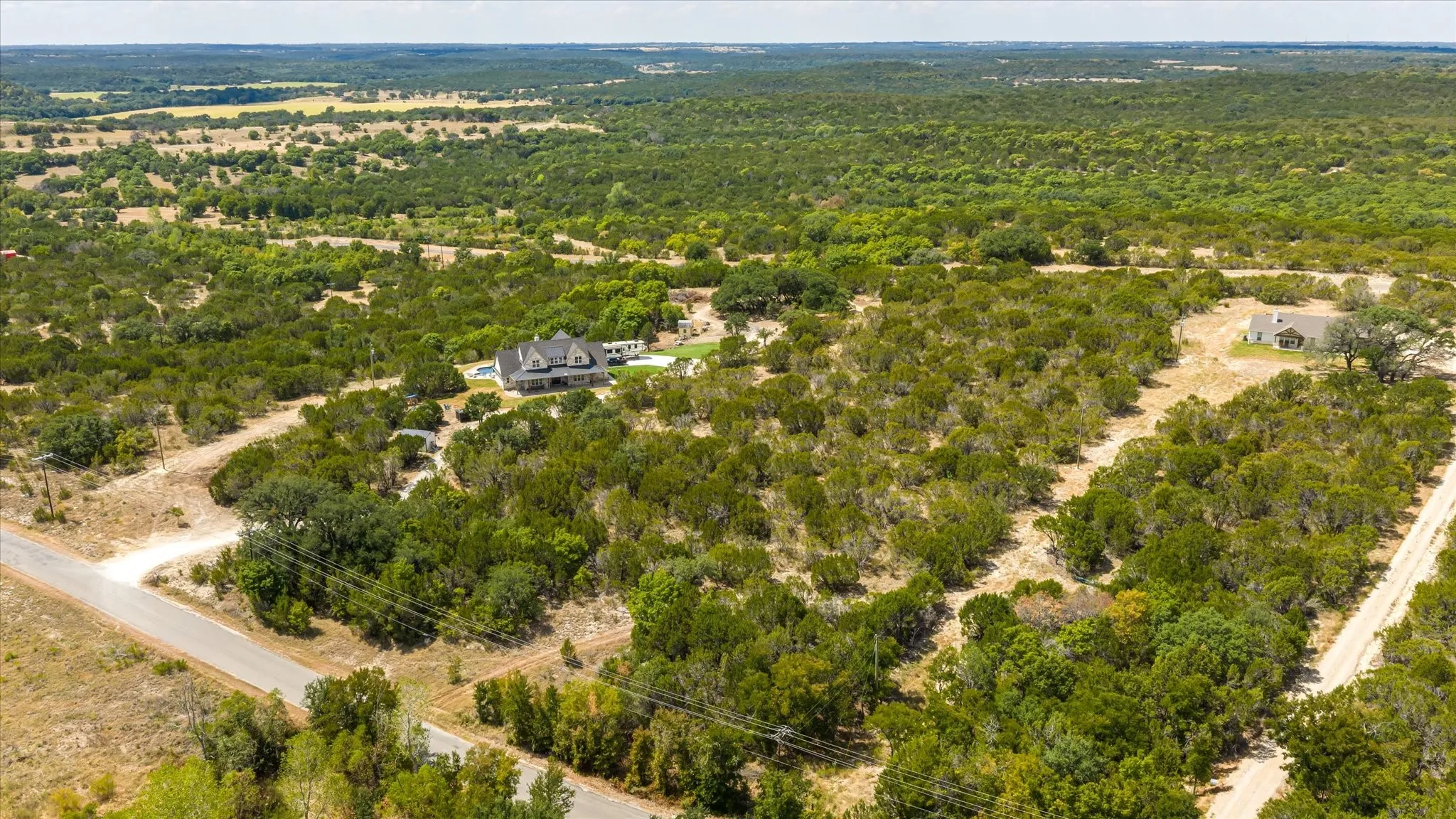 Expansive wooded acreage with a main residence and an additional structure