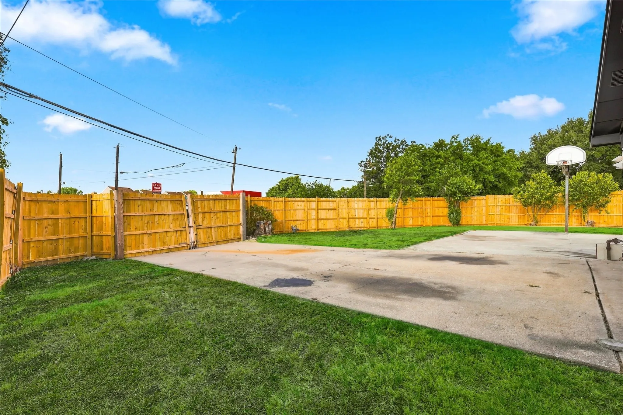 New fence in back yard with gate for driveway to protect vehicles and trailers.