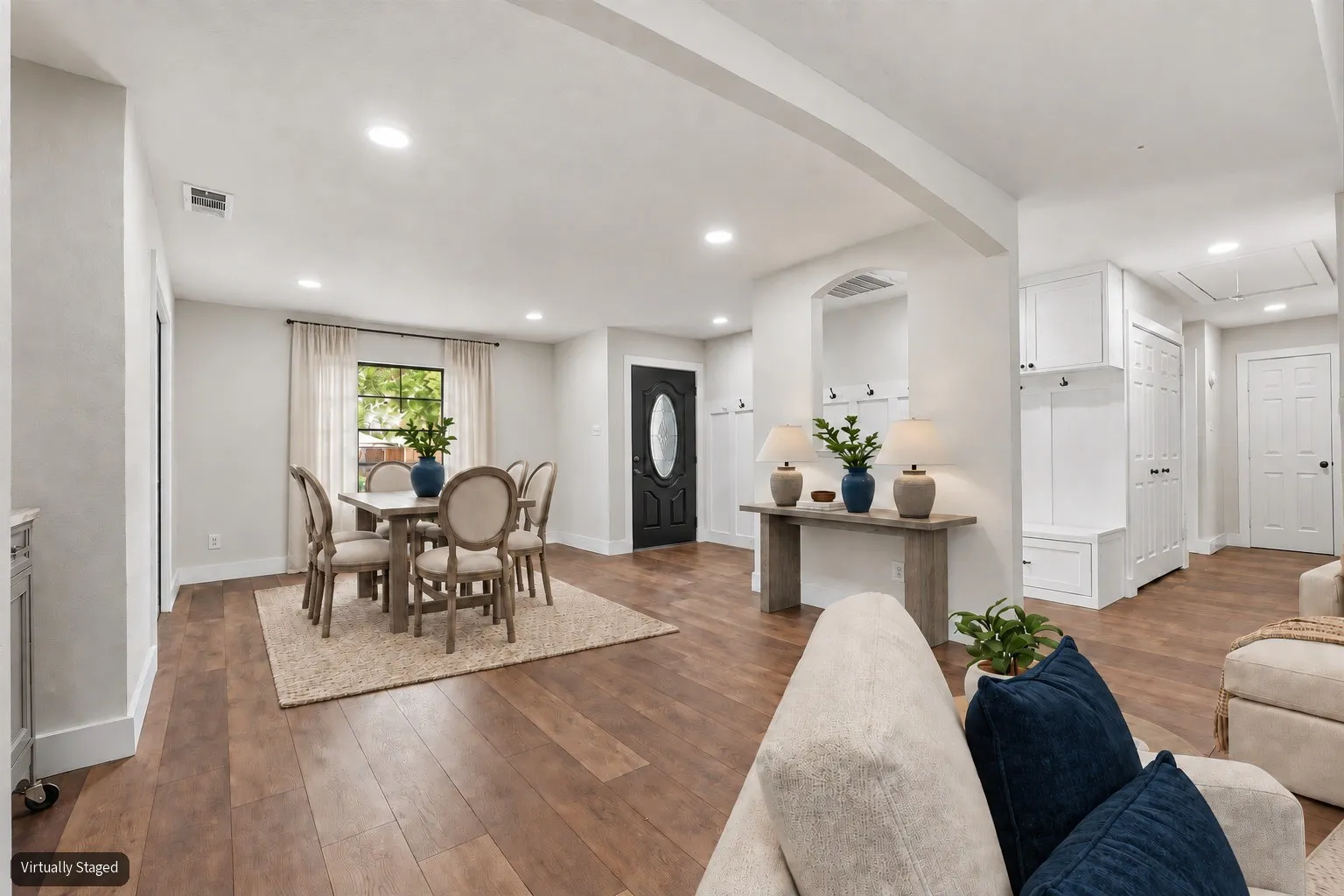 Virtually Staged Dining Area and view of entryway.