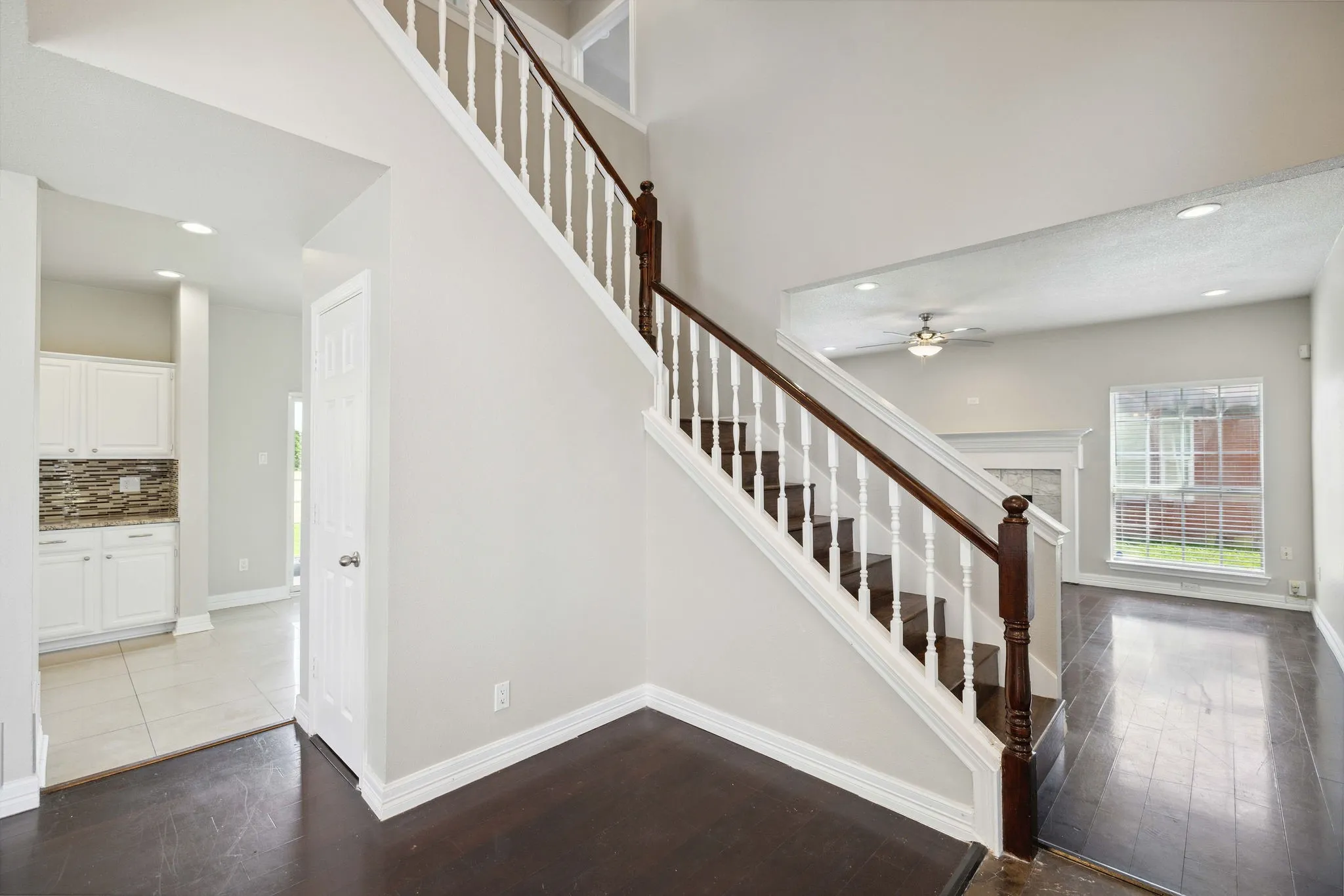 Stairs with ceiling fan and light tile floors