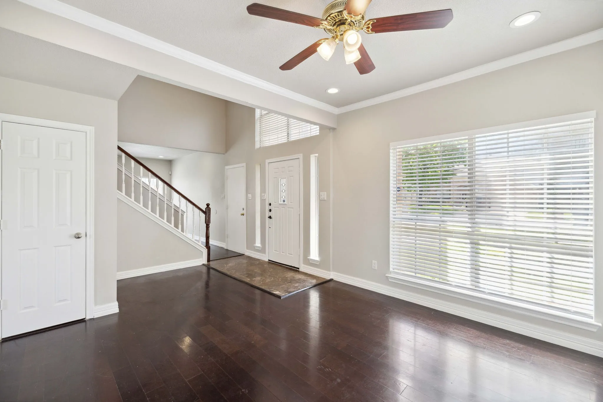 Foyer featuring ceiling fan, dark hardwood / wood-style flooring, and ornamental molding