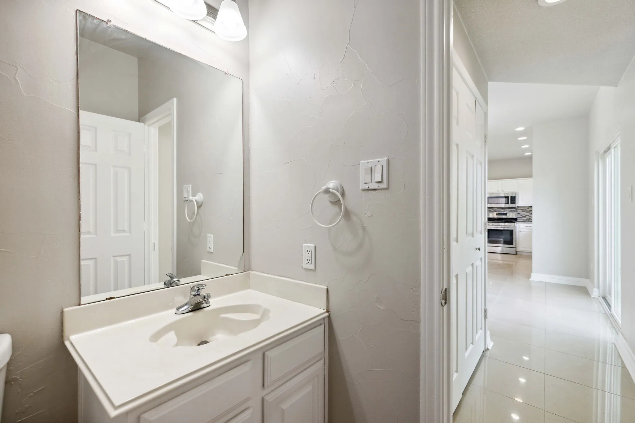 Bathroom featuring tile flooring, oversized vanity, and toilet