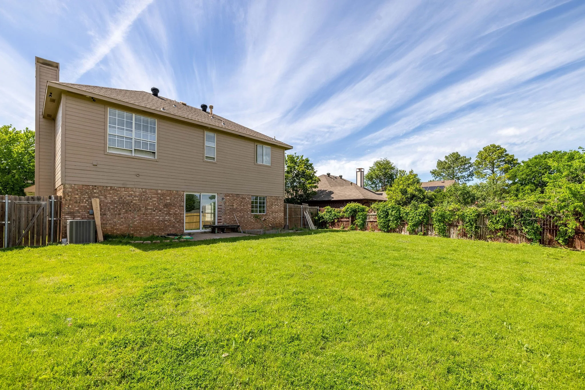 Back of house with a patio area, central air condition unit, and a lawn