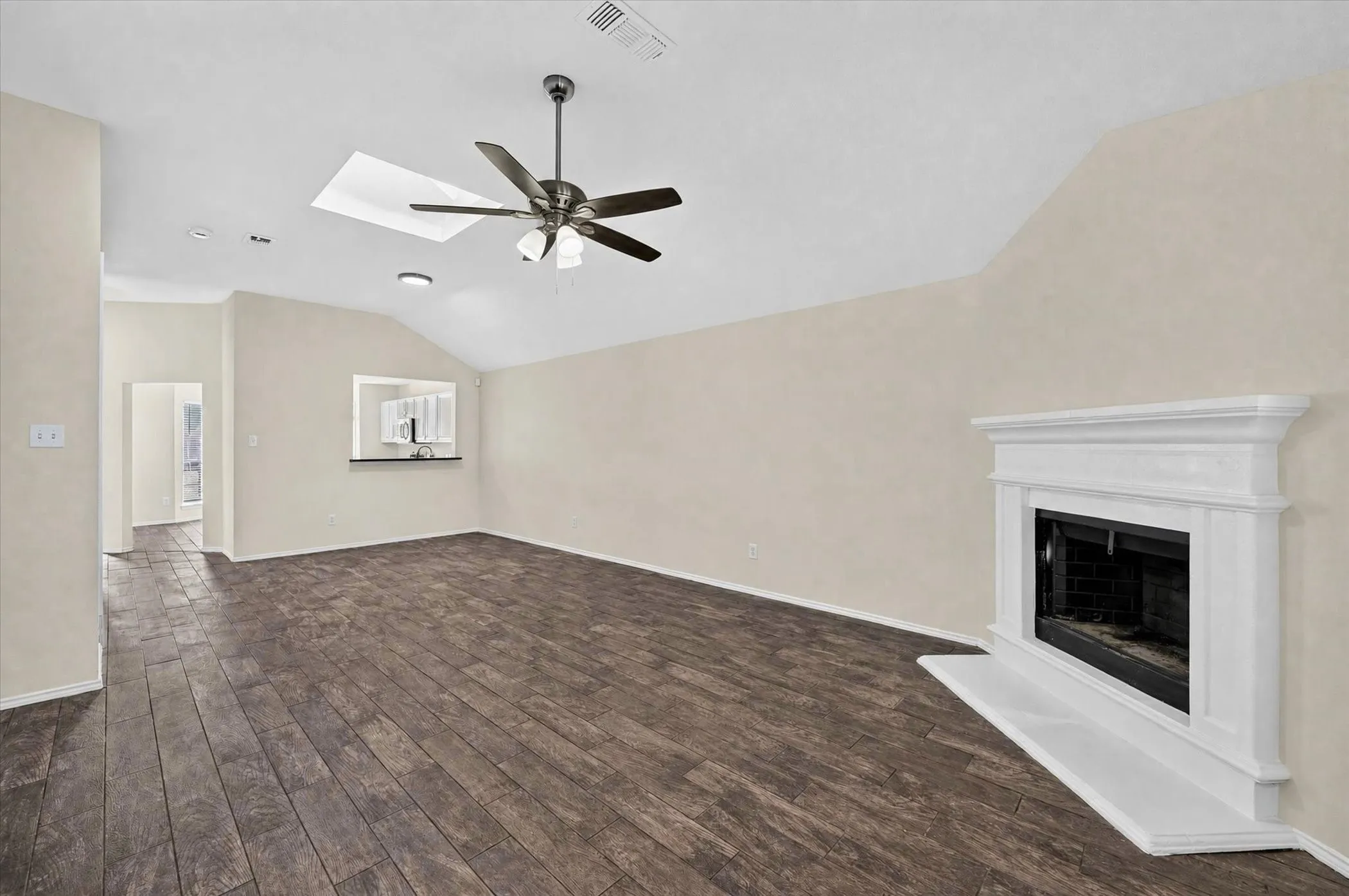 Vaulted ceilings with a skylight and ceiling fan