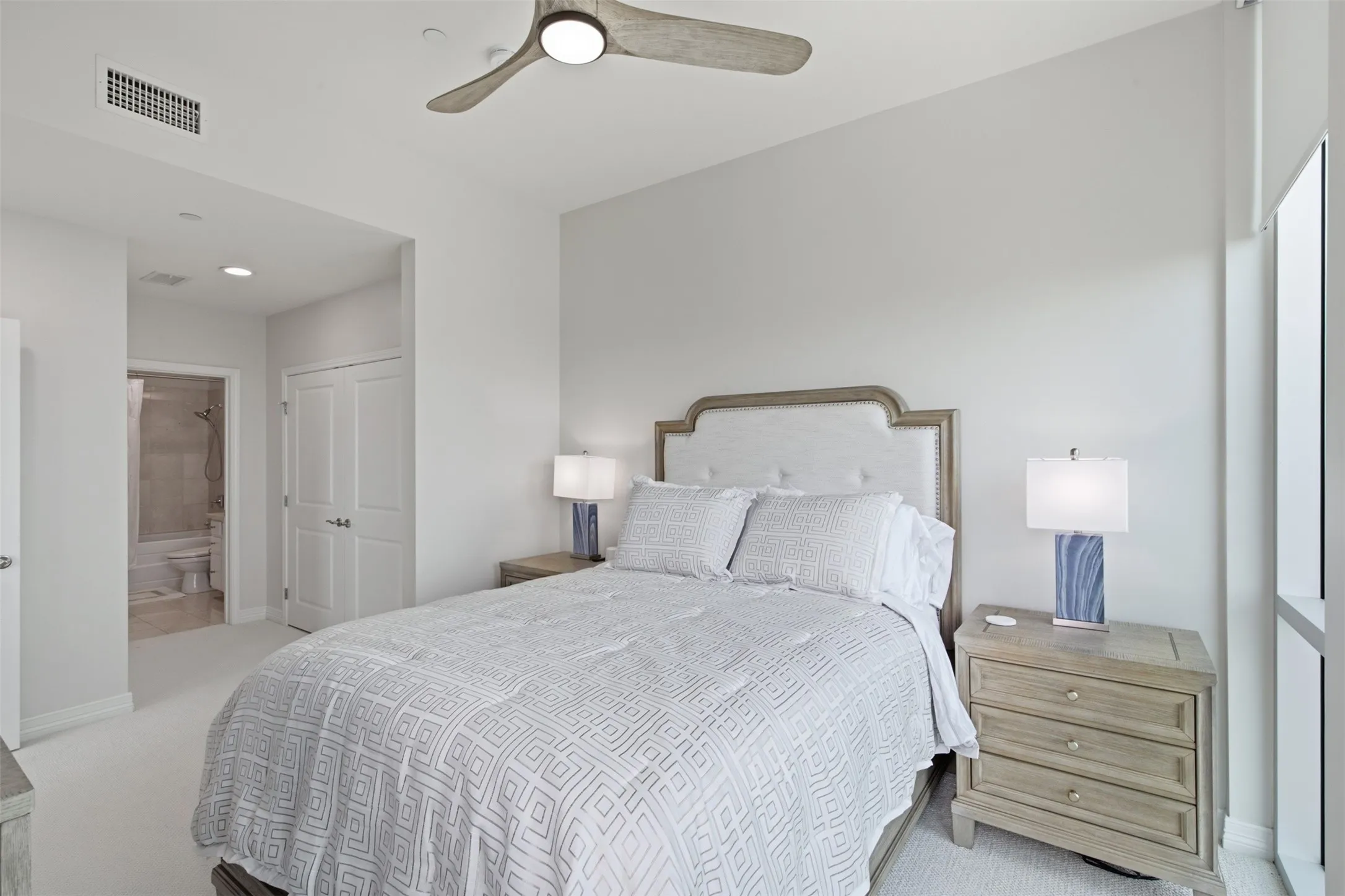 Neutral wall tones, recessed lighting, ceiling fan, carpeted flooring, and a bath with tile flooring