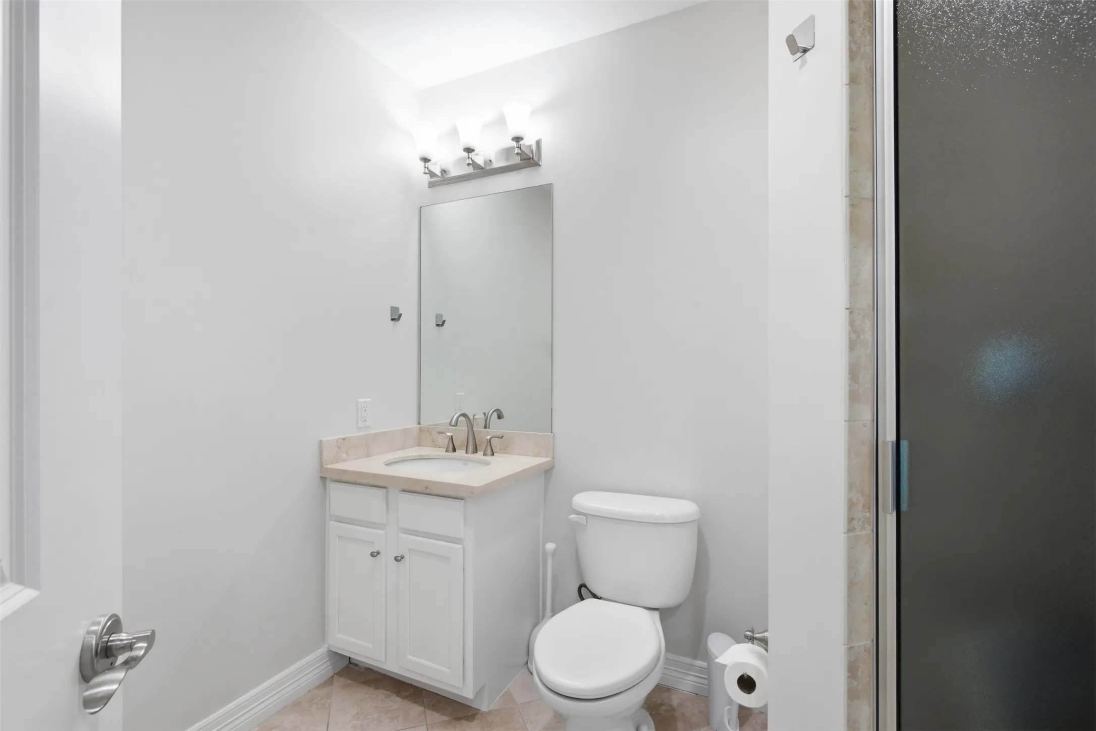 Bath #2 Vanity with a light-toned countertop, mirrored wall, and built-in toilet, Separate Shower