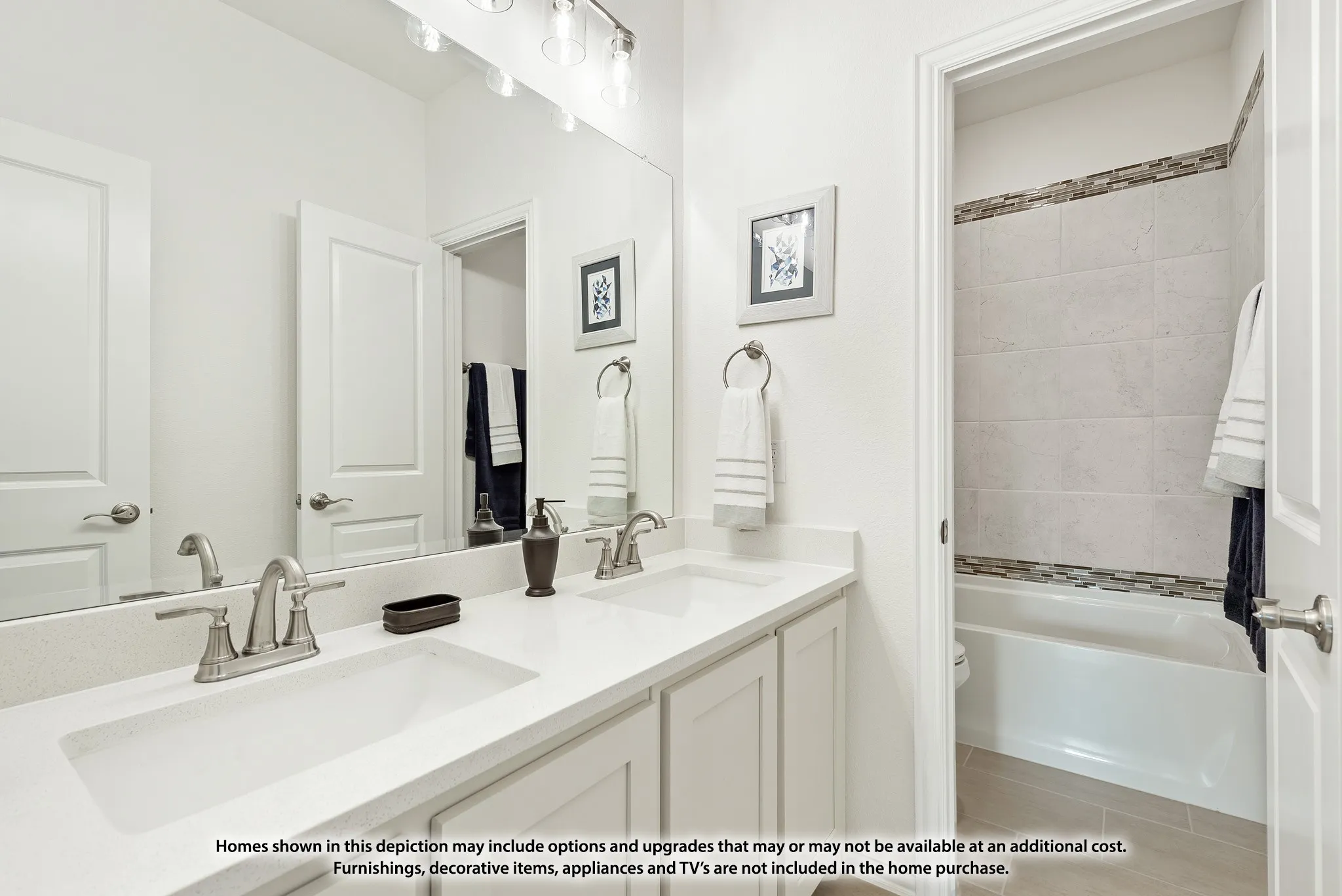 Master bathroom featuring dual vanities with white cabinetry, quartz countertops, and brushed nickel faucets