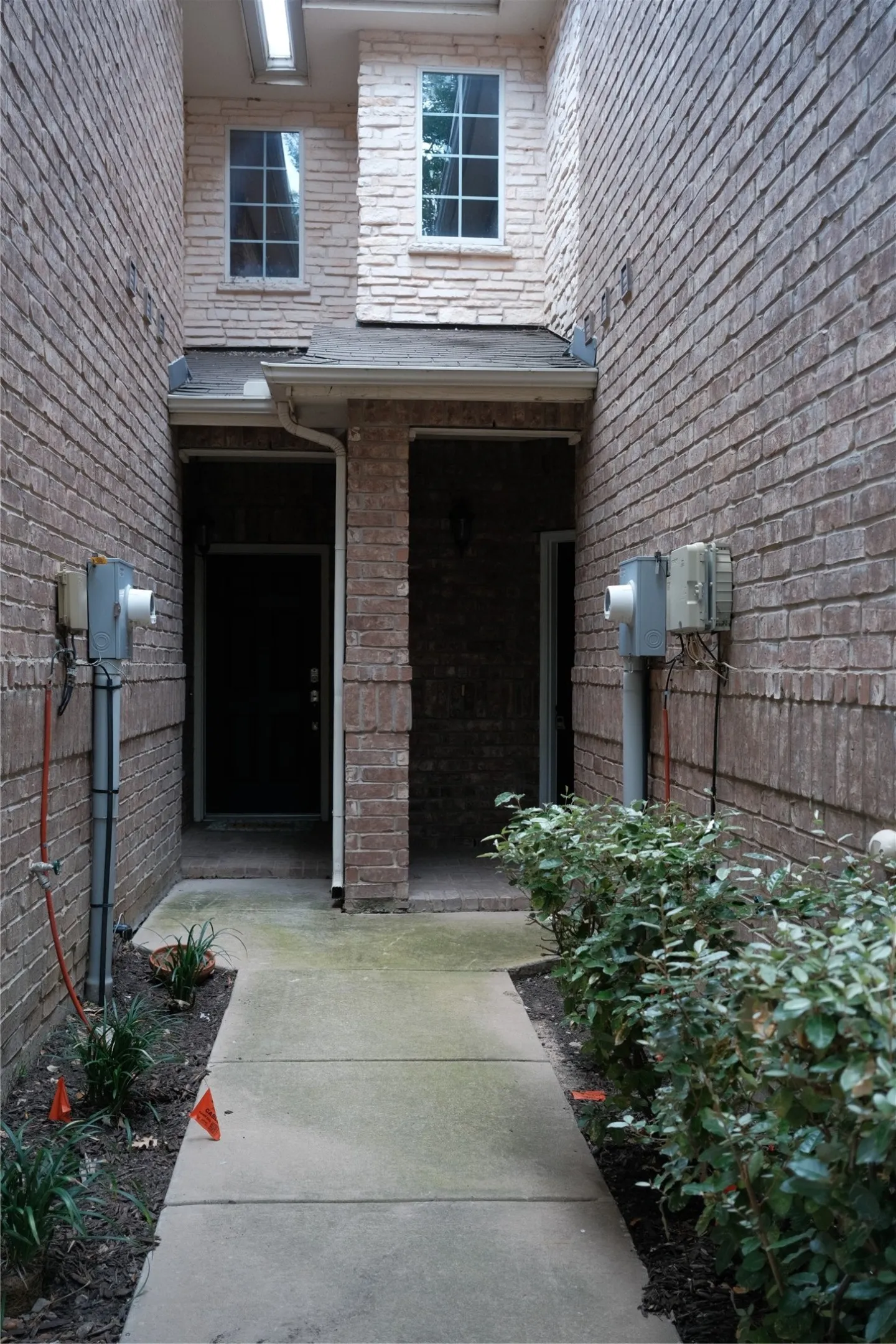 Brick exterior with stone accents and multiple windows