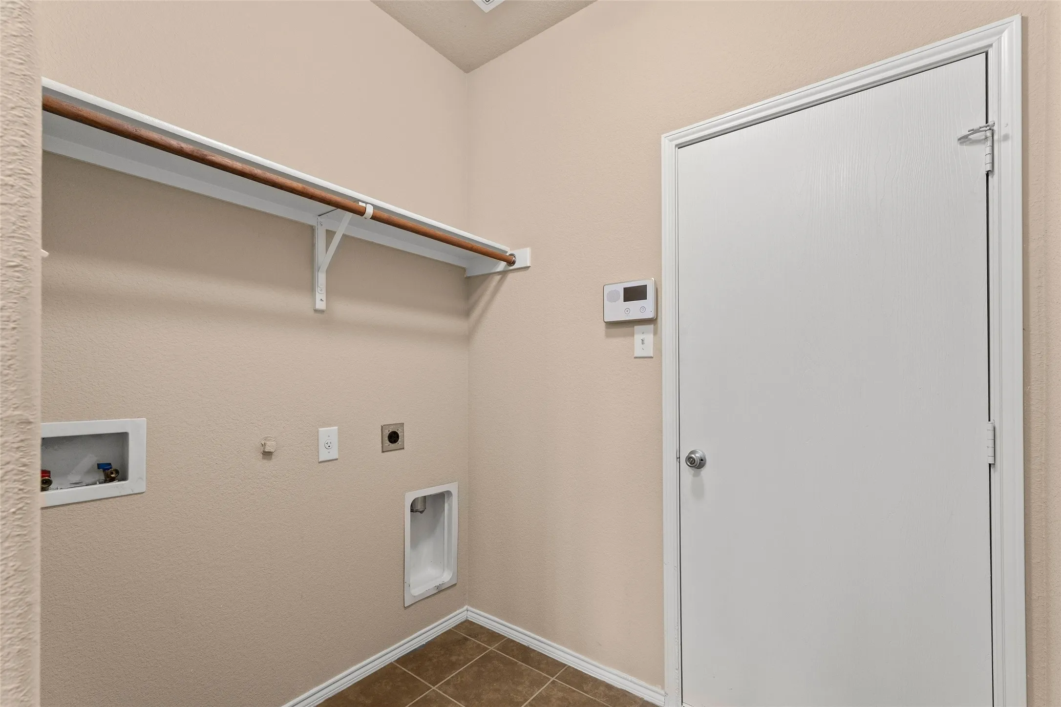 Laundry room with gas dryer hookup, dark tile patterned flooring, washer hookup, and electric dryer hookup