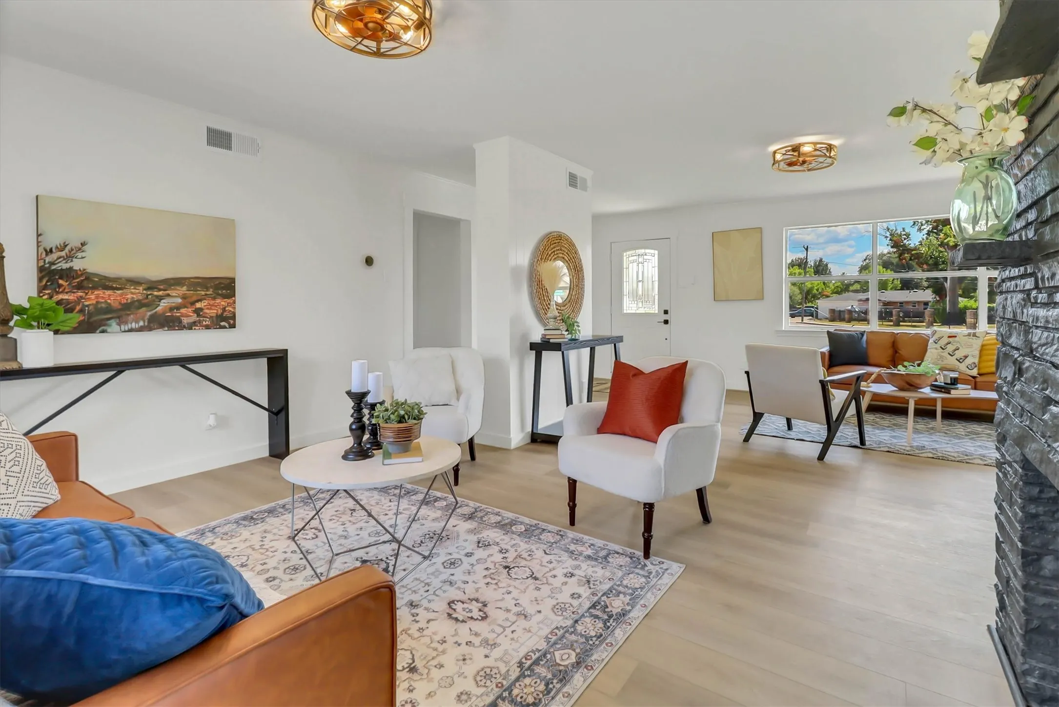 Light wood-finish flooring, white walls, recessed lighting, and a front entry door with decorative glass panels