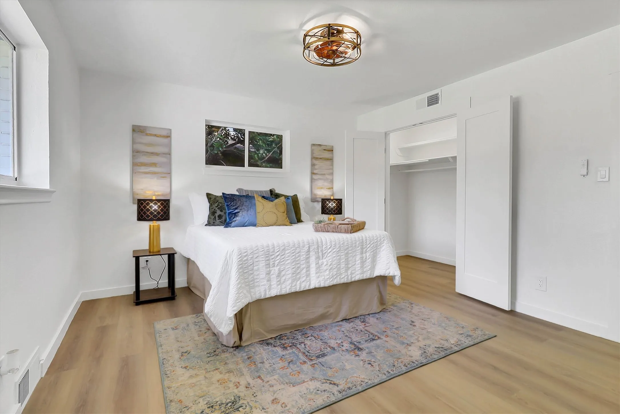 Wood-finish flooring with white walls and a ceiling-mounted light fixture