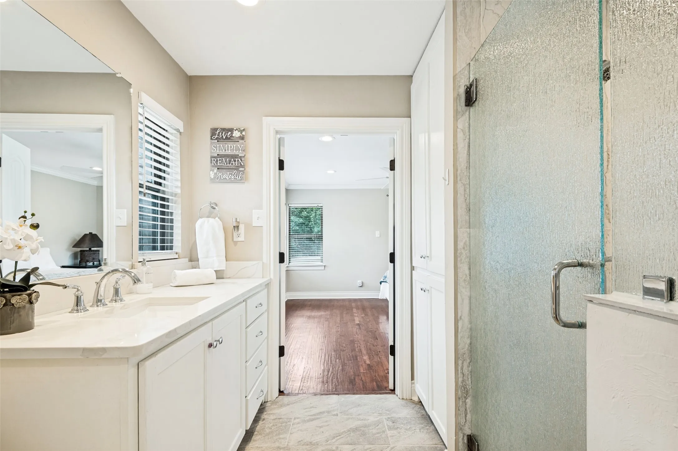 Single vanity with undermount sinks, white cabinetry, and a light-toned countertop