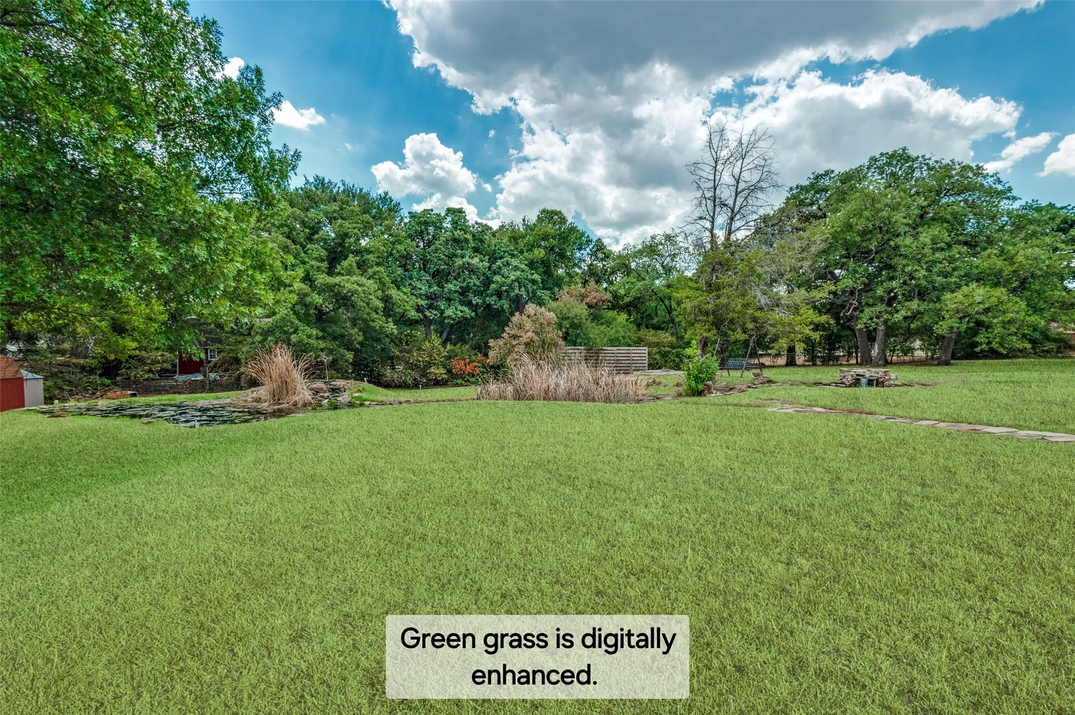 Expansive lawn with mature trees and a tranquil pond feature