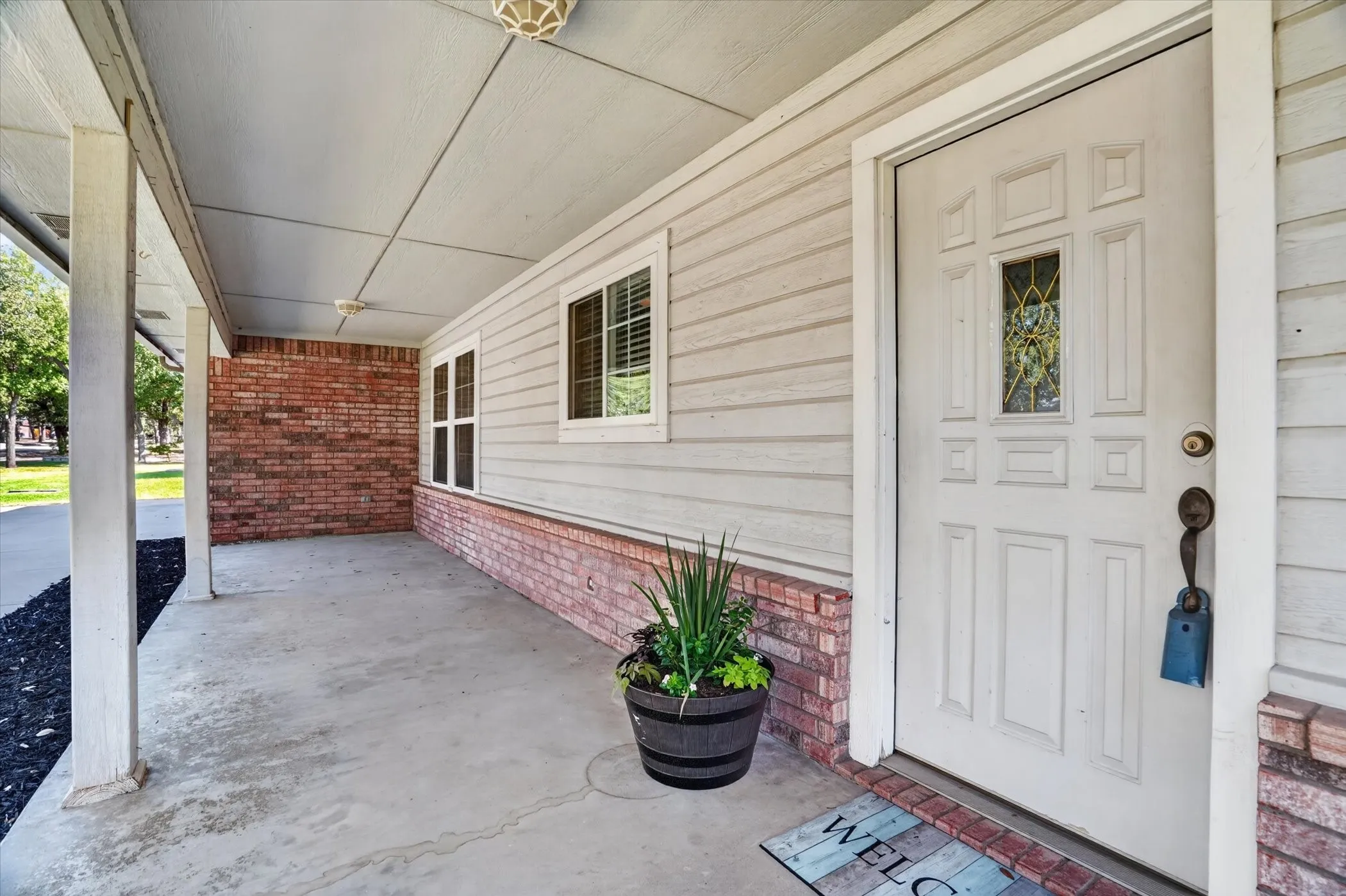 Covered front porch with concrete flooring