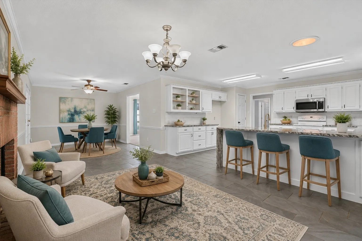 Virtually Staged
Open-concept living area featuring a brick fireplace, dark tile flooring, and a dining space with a ceiling fan