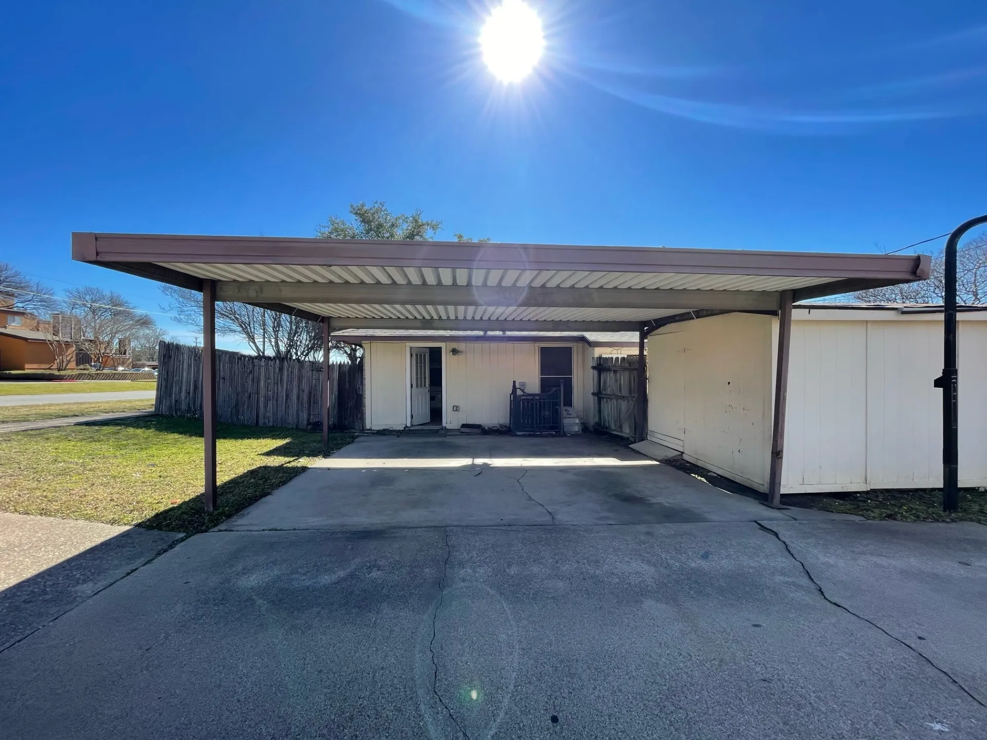 View of parking / parking lot featuring driveway