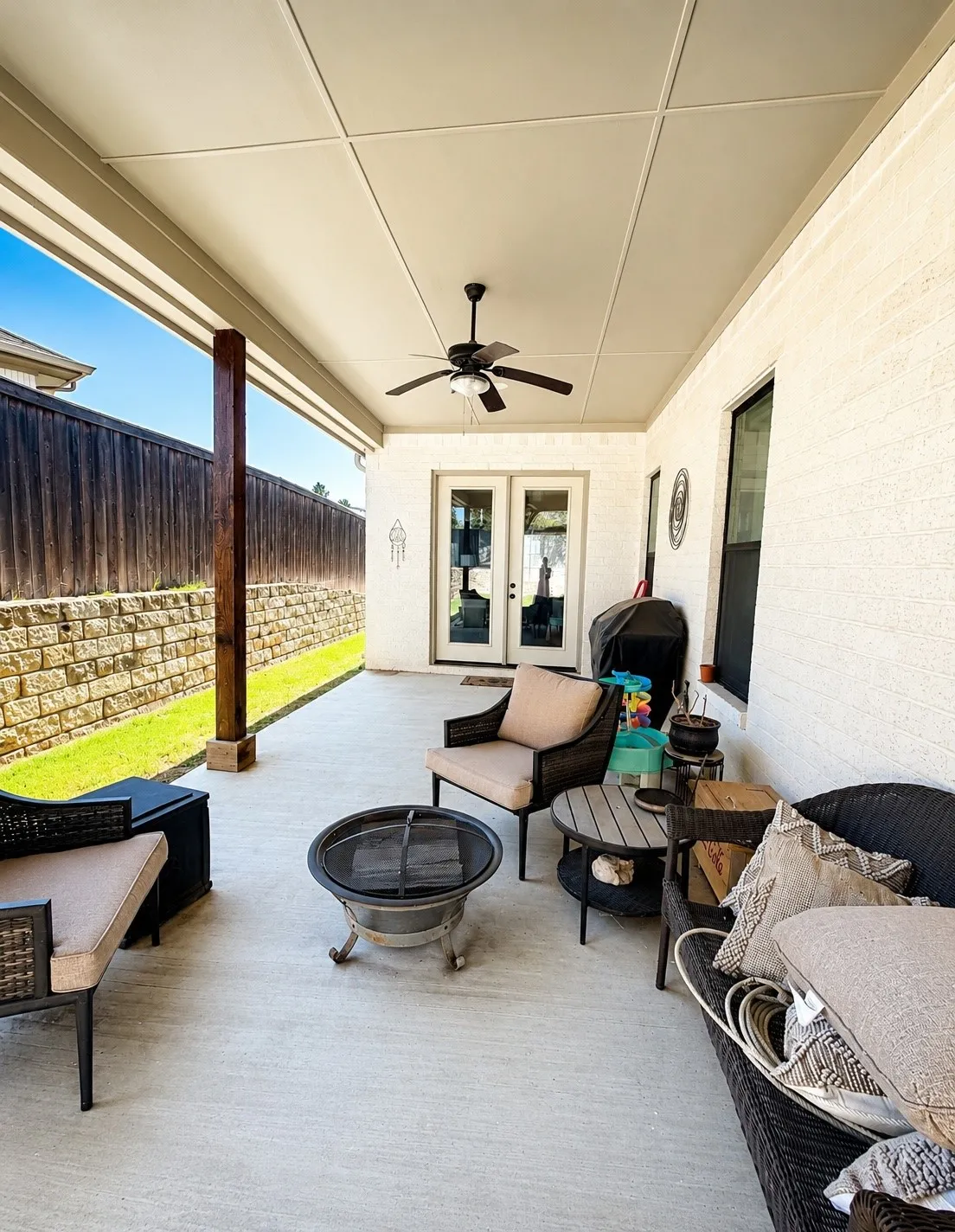 Covered back patio with ceiling fan and room for outdoor living