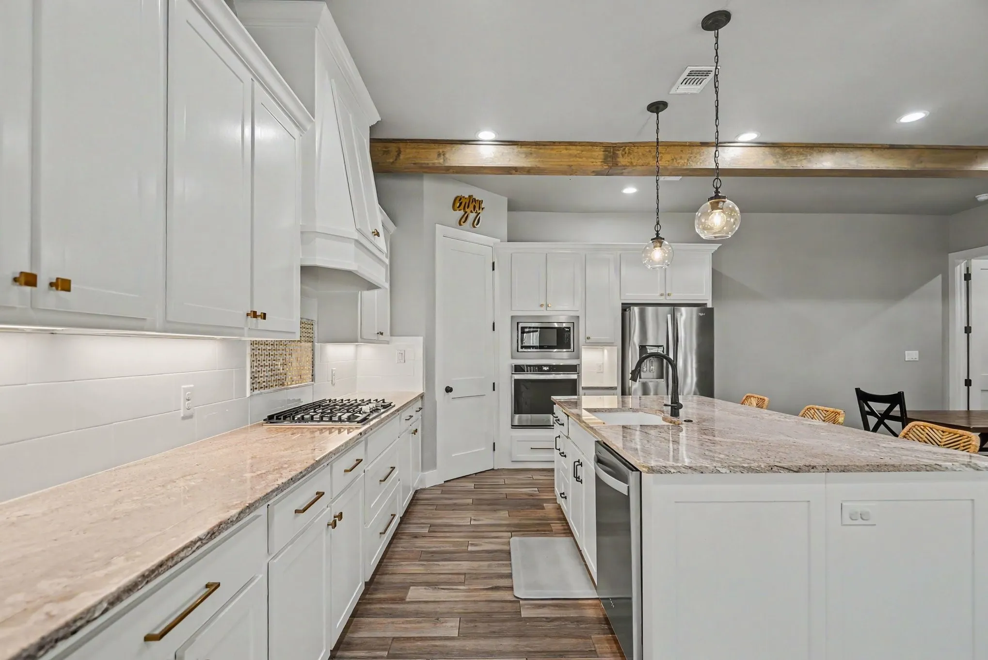 Kitchen boasts ample cabinets and countertop space and gas stovetop