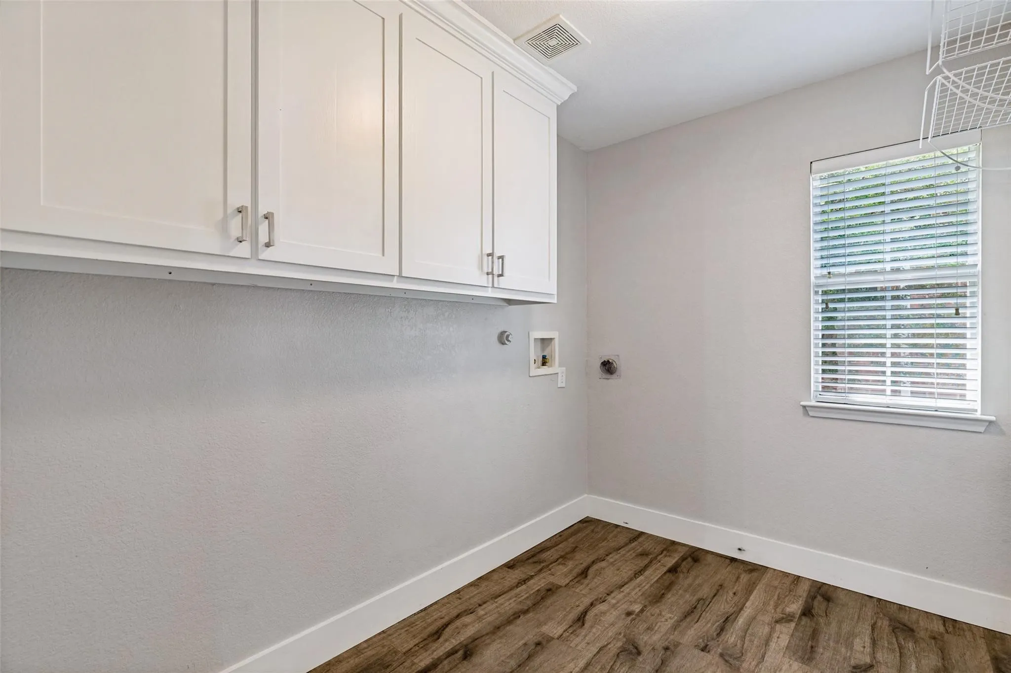White shaker-style cabinetry with brushed nickel hardware