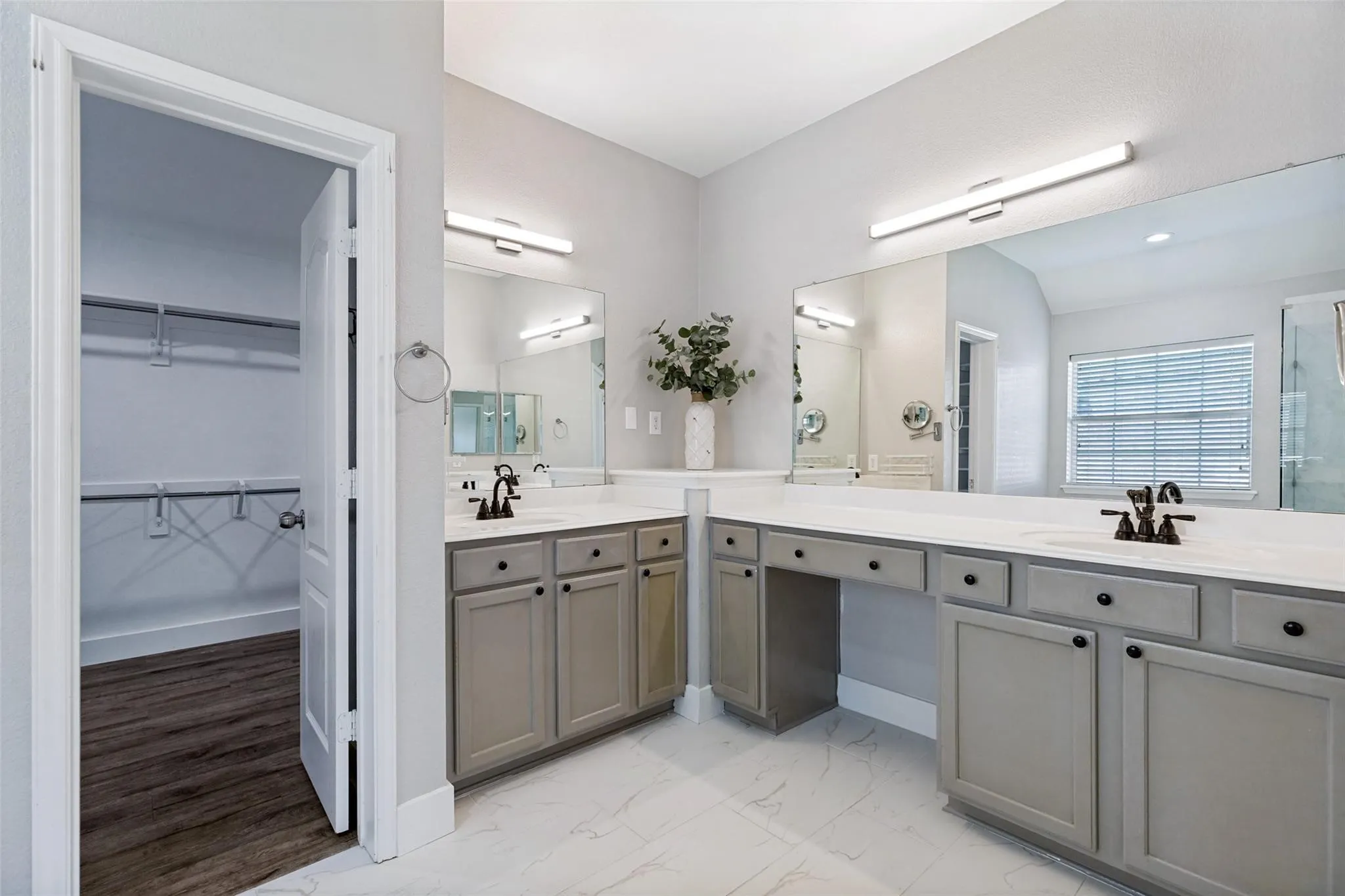 Dual vanity with undermount sinks, stone countertops, and dark bronze fixtures
