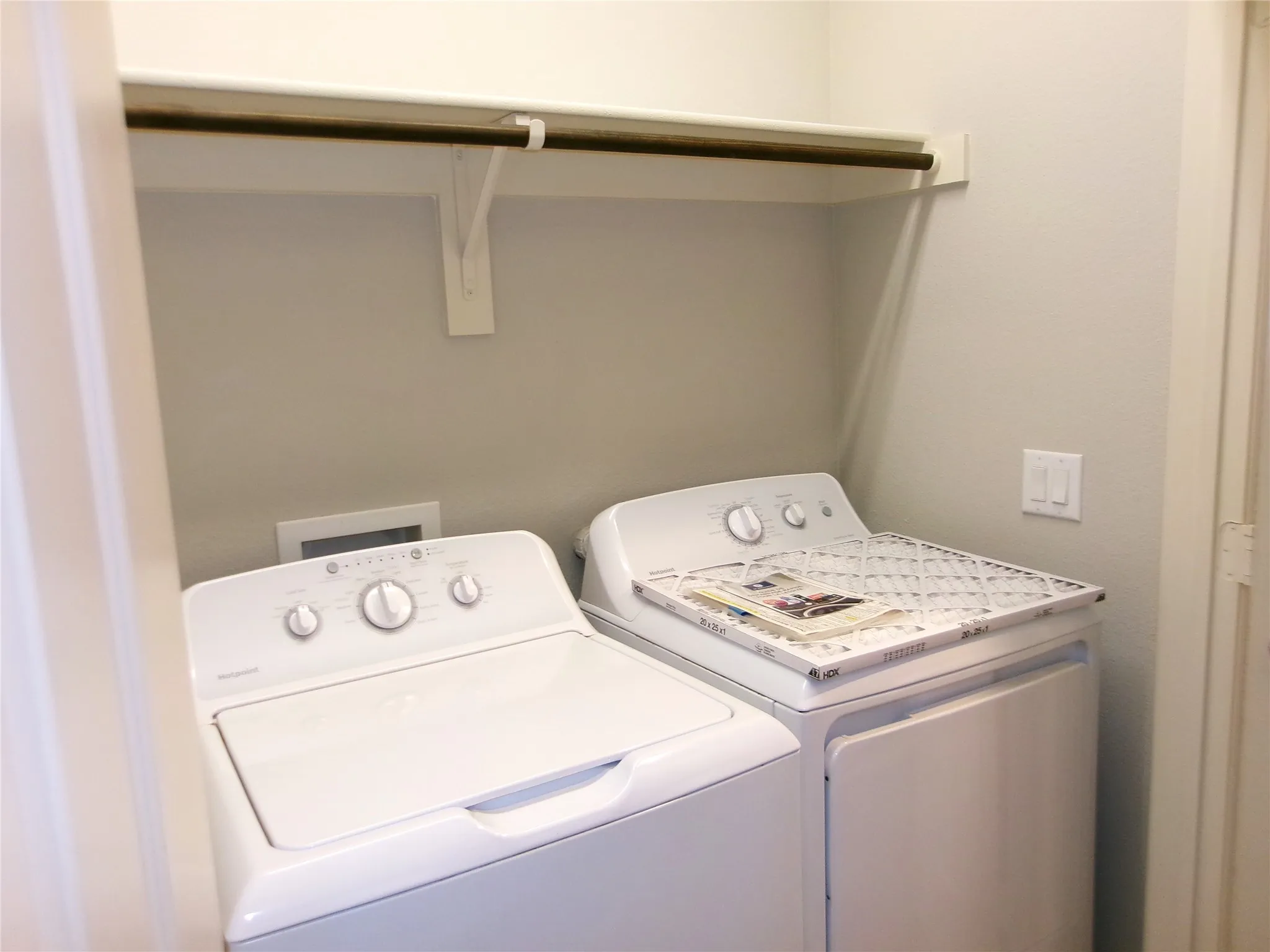 Laundry room located in hallway showing washer and dryer