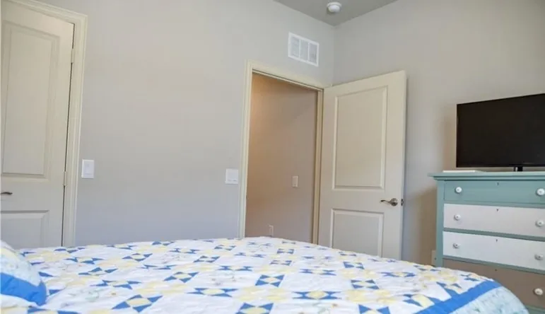 Secondary bedroom showing queen size bed and dresser