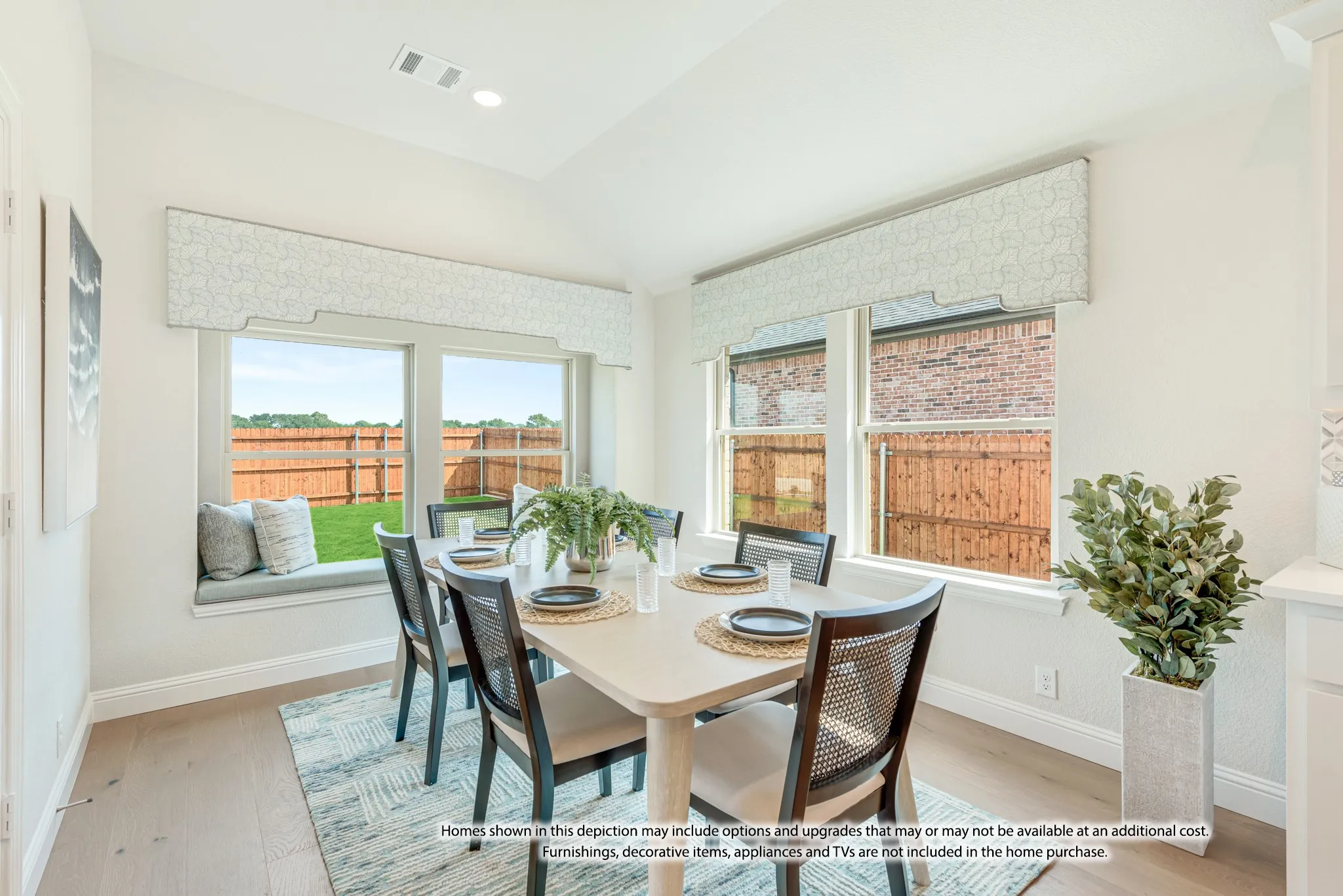 Recessed lighting, sloped ceiling, wood-finish flooring, built-in window seat, and backyard fencing