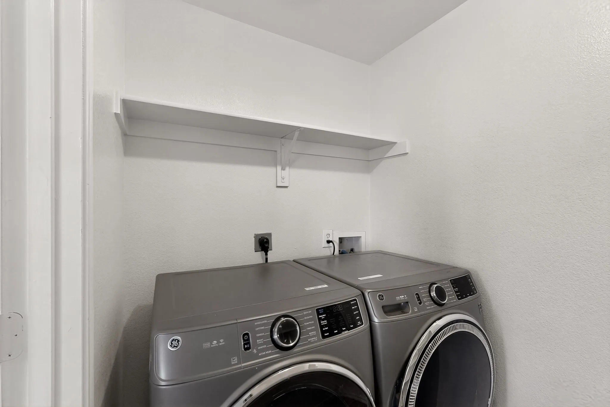 1st floor Laundry area featuring a wall-mounted shelf and appliance hookups