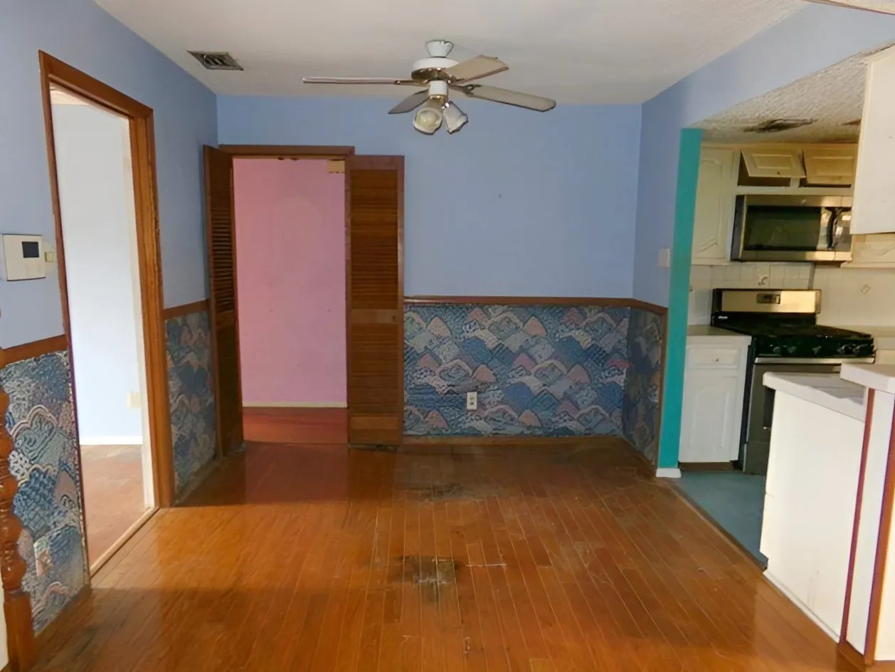 Hardwood-style flooring with a ceiling fan overhead