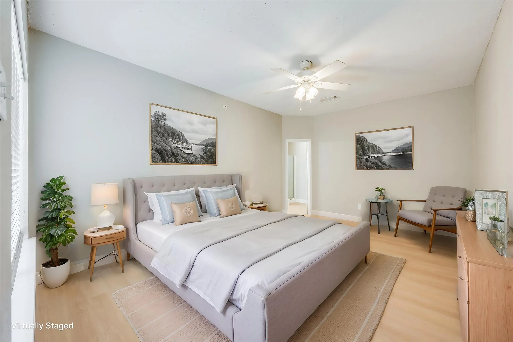 Light wood-finish flooring, bright interior paint, ceiling fan, and window with blinds