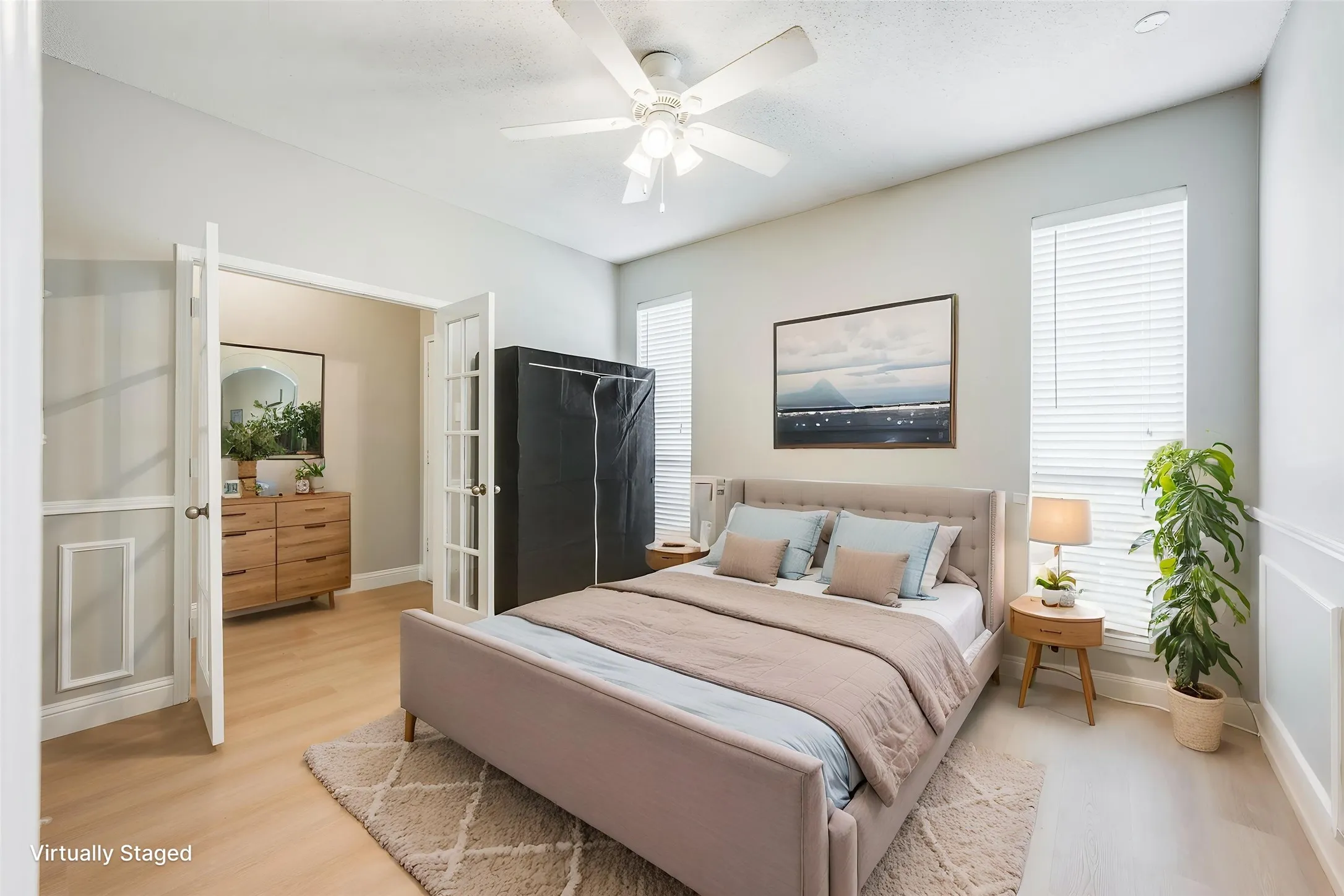 Recessed lighting, ceiling fan, wood-finish flooring, two windows with blinds, and decorative wall paneling
