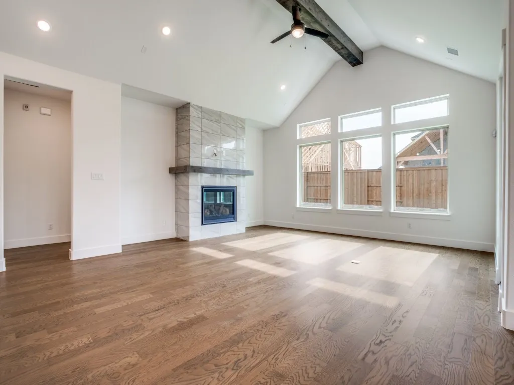 Wonderful family memories are waiting to be made in this spacious family room featuring a lovely fireplace, beautiful flooring and stunning center ceiling beam!