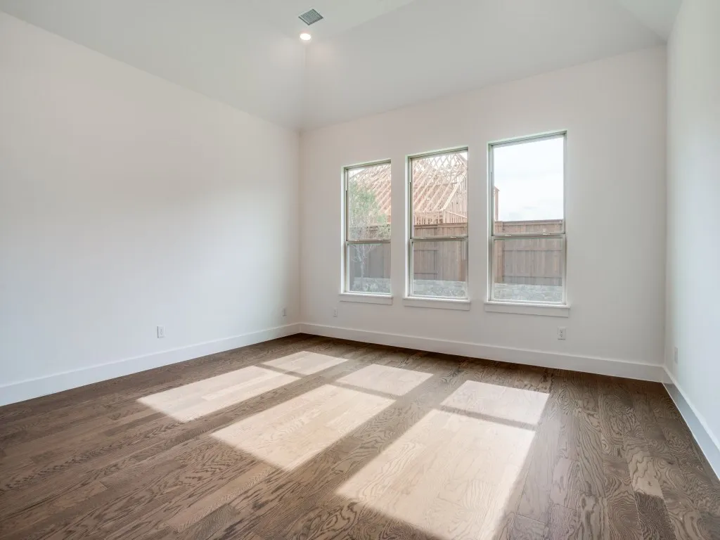 Featuring high ceilings, a wall of windows and beautiful flooring, your new owner's suite is a haven for rest and relaxation.