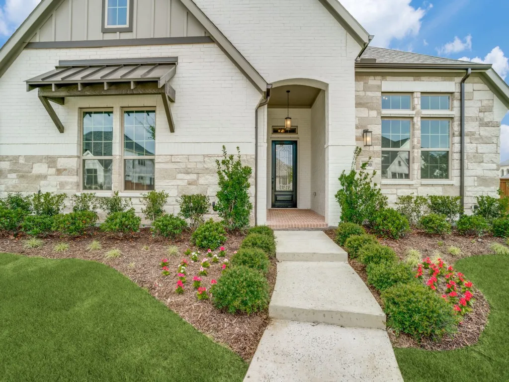 Beautiful painted brick paired with gorgeous stone and lush landscaping create fantastic curb appeal in this forever home!