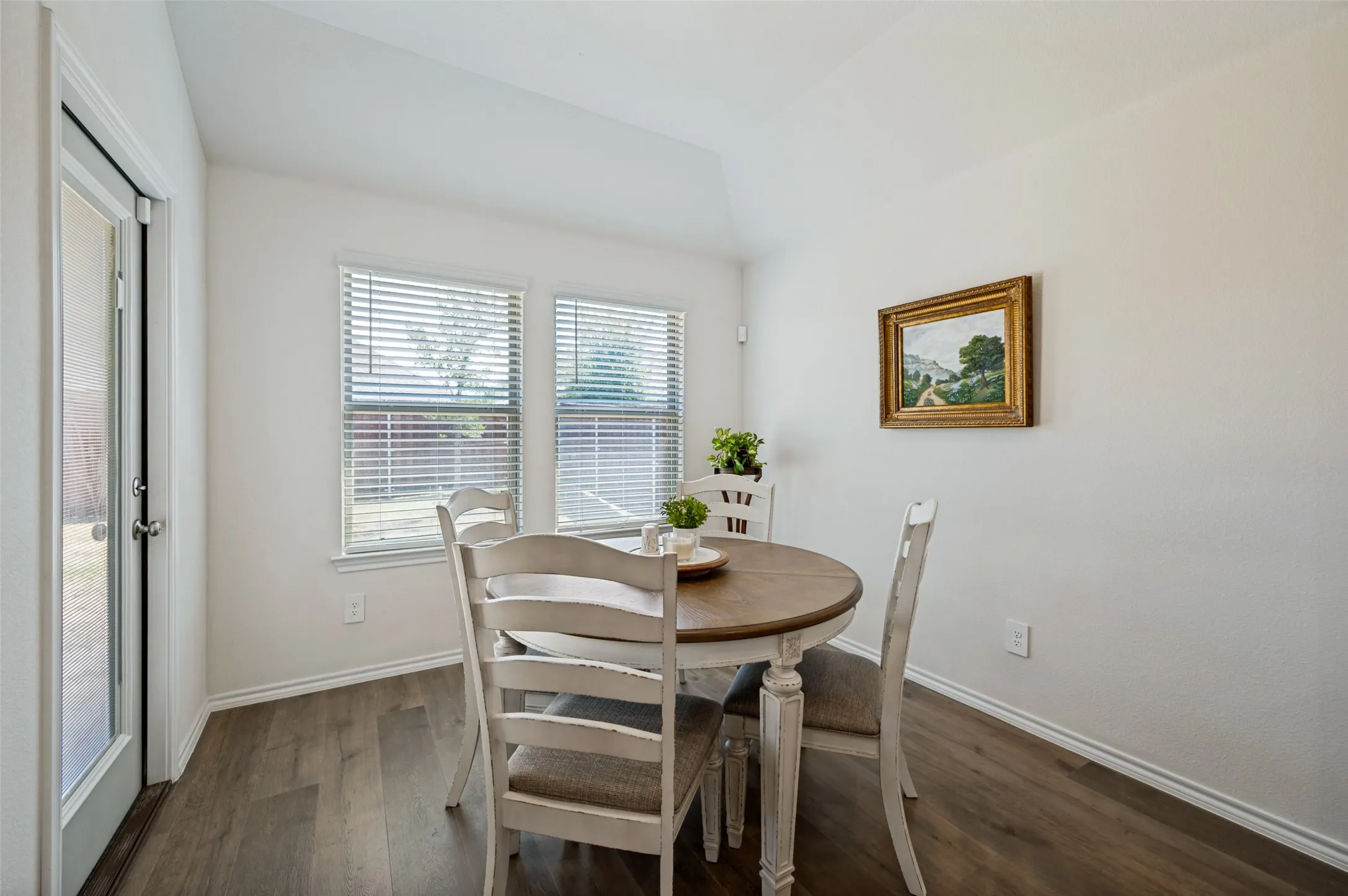 Dining space with a door to backyard and windows overlooking the yard!