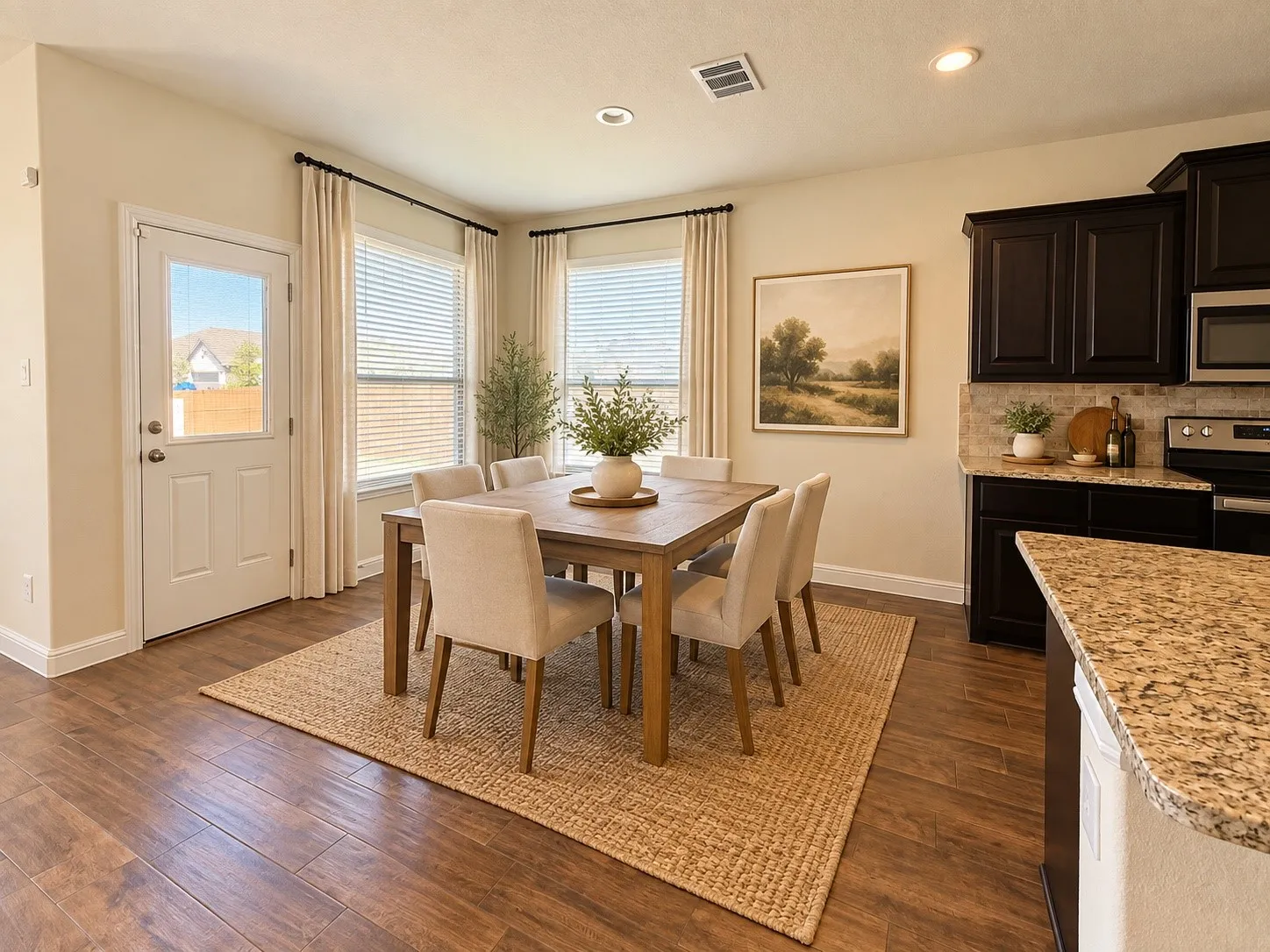 Dining area featuring wood-finish flooring, recessed lighting, and ample natural light from multiple windows