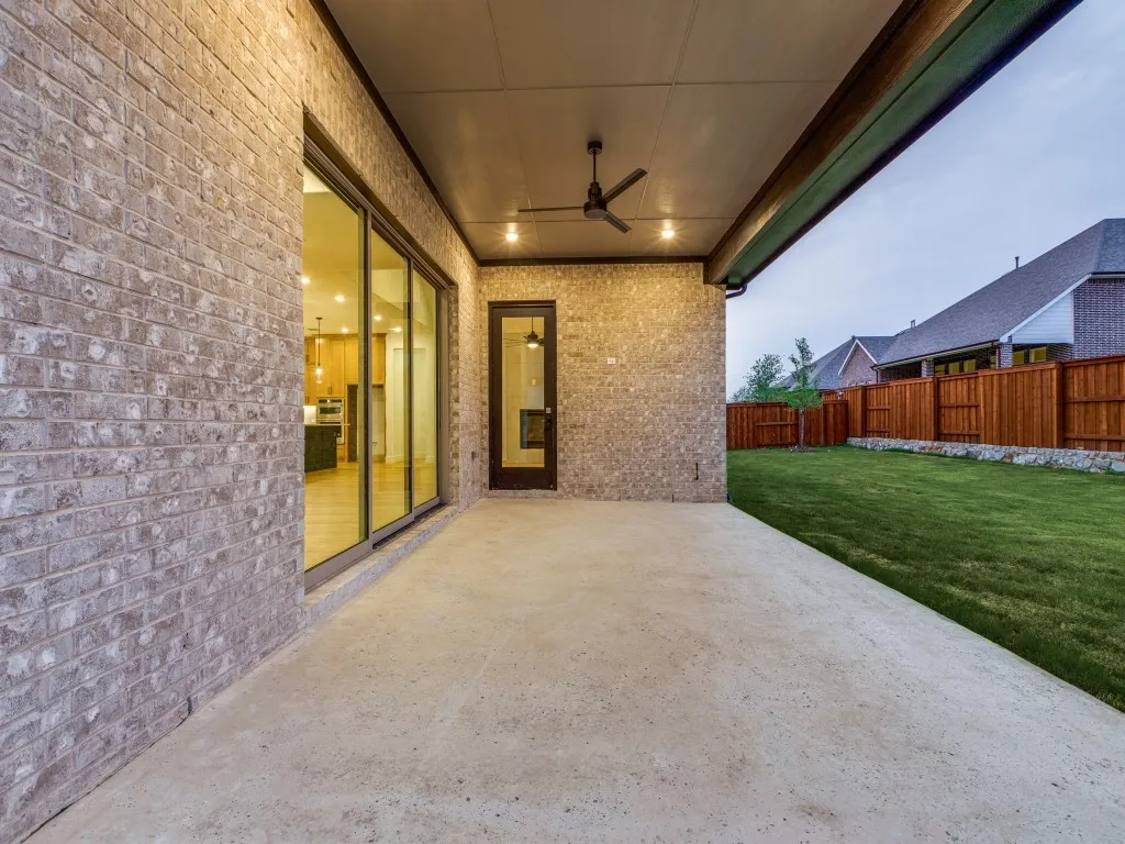 Featuring a multi panel sliding door, it's easy to take the party outside to this lovely covered patio and fenced back yard!