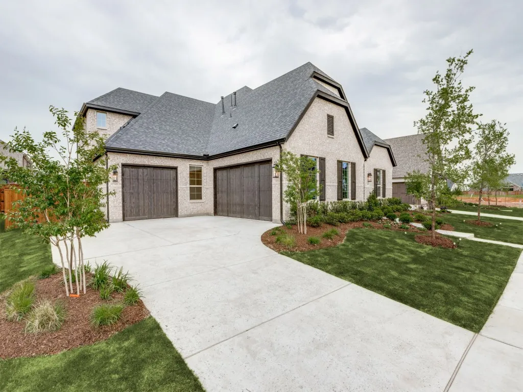 Your new dream home features beautiful cream colored brick paired with striking dark trim color to create fantastic curb appeal!
