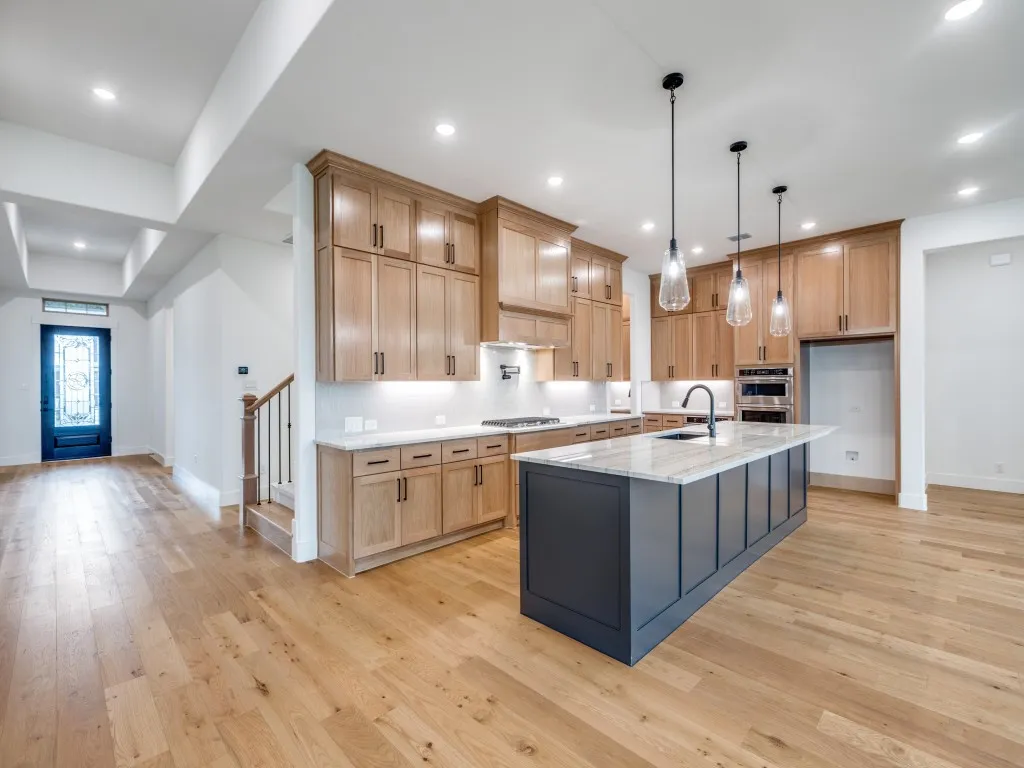 Offering gorgeous flooring, dual stacked cabinetry and a striking oversized island, this dream kitchen is everything you have been searching for!