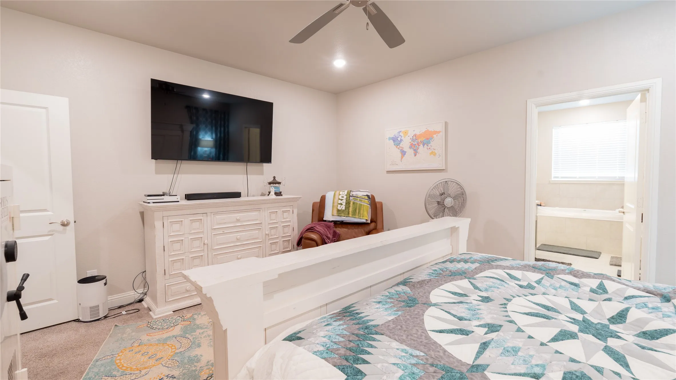 Recessed lighting, ceiling fan, and light neutral wall colors