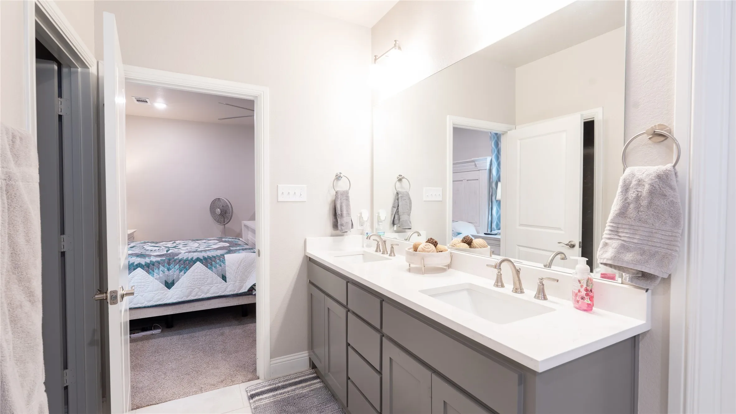Double vanity with white countertops, undermount sinks, and brushed nickel fixtures