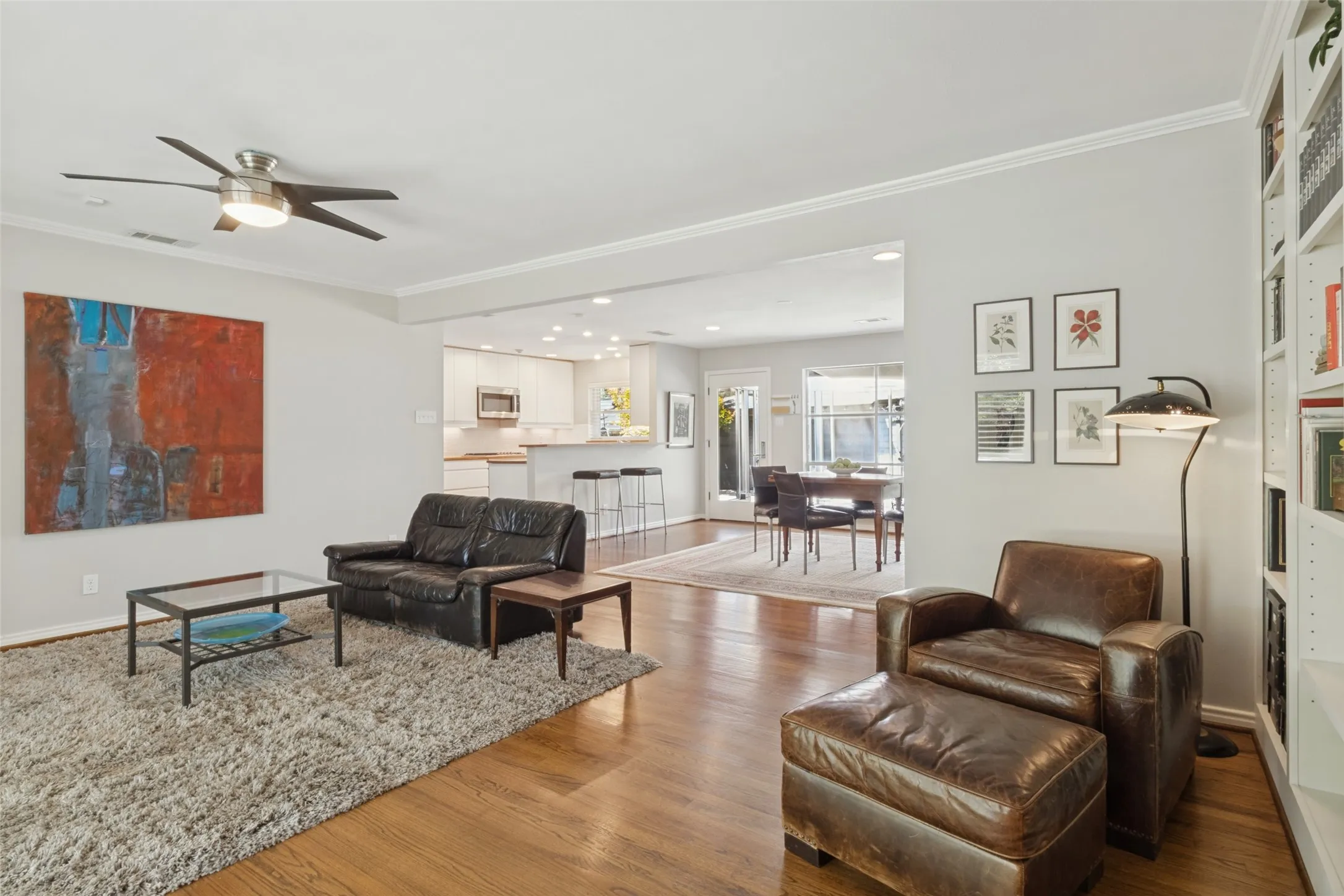 Original Hardwood floors flooring throughout, crown molding, and a ceiling fan with integrated lighting