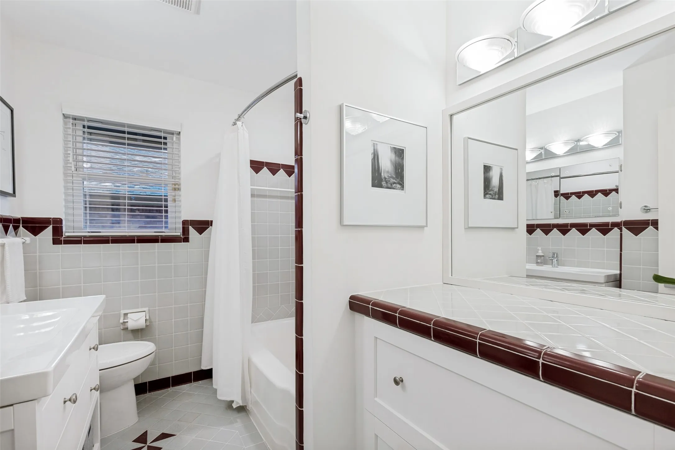 White tile flooring with decorative brown accents